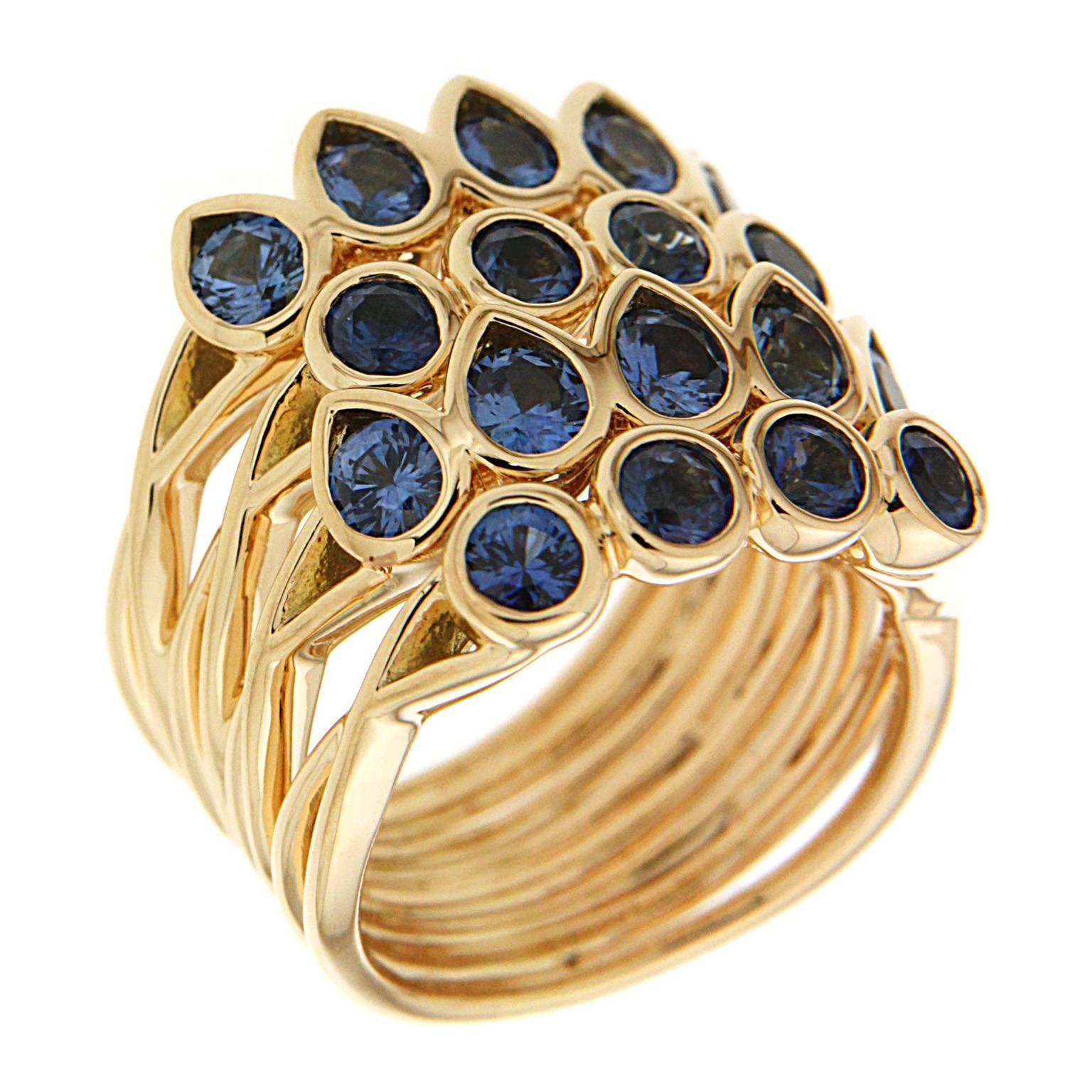 This unique ring features four Pear Shape and Round Sapphire stacking bands with slight flexibility. The ring is finished in 18kt yellow gold. 

Current finger size 6.5 - can be adjusted to fit your finger size.