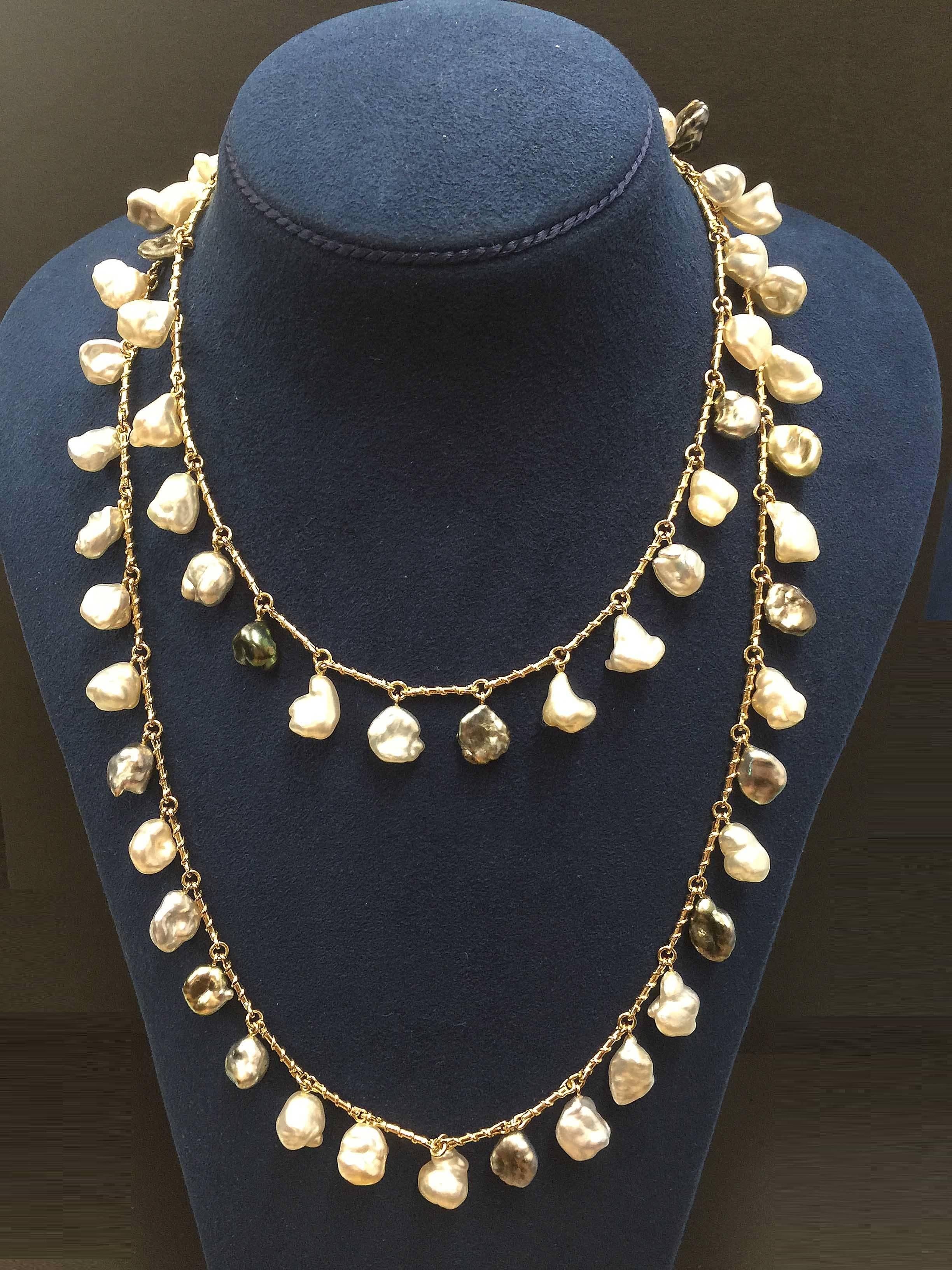 This unique necklace features various of colors of Keshi Pearls dangling with special designed twisted wire gold links. This necklace design allows for a bold statement of personal style – no matter the hour or occasion. The necklace is finished in