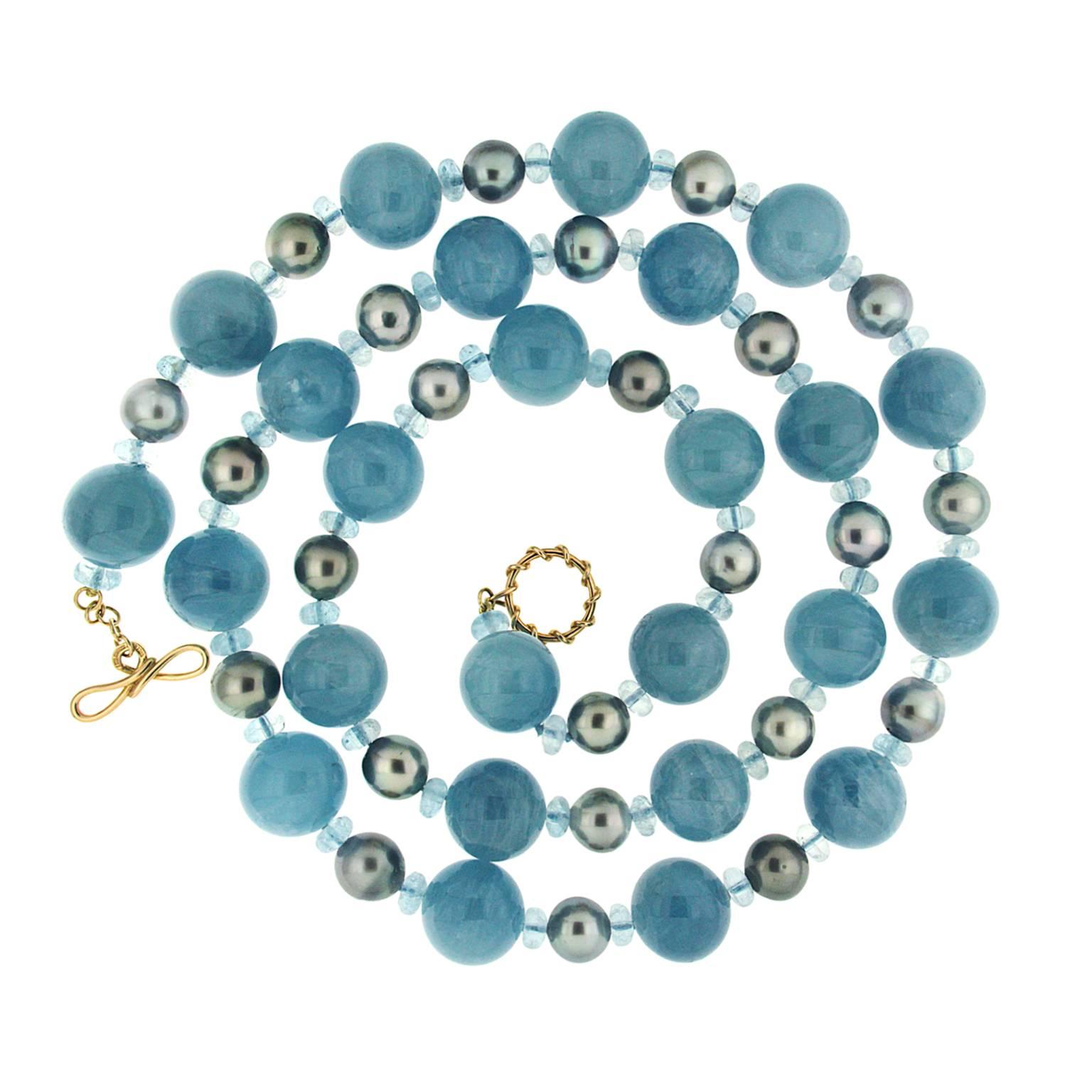 This unique necklace features twenty three 18 mm aquamarine balls with 22 Tahitian pearls  and 7mm aquamarine roundels. The necklace is finished in 18kt yellow gold with Medium plain knot with wire link toggle.