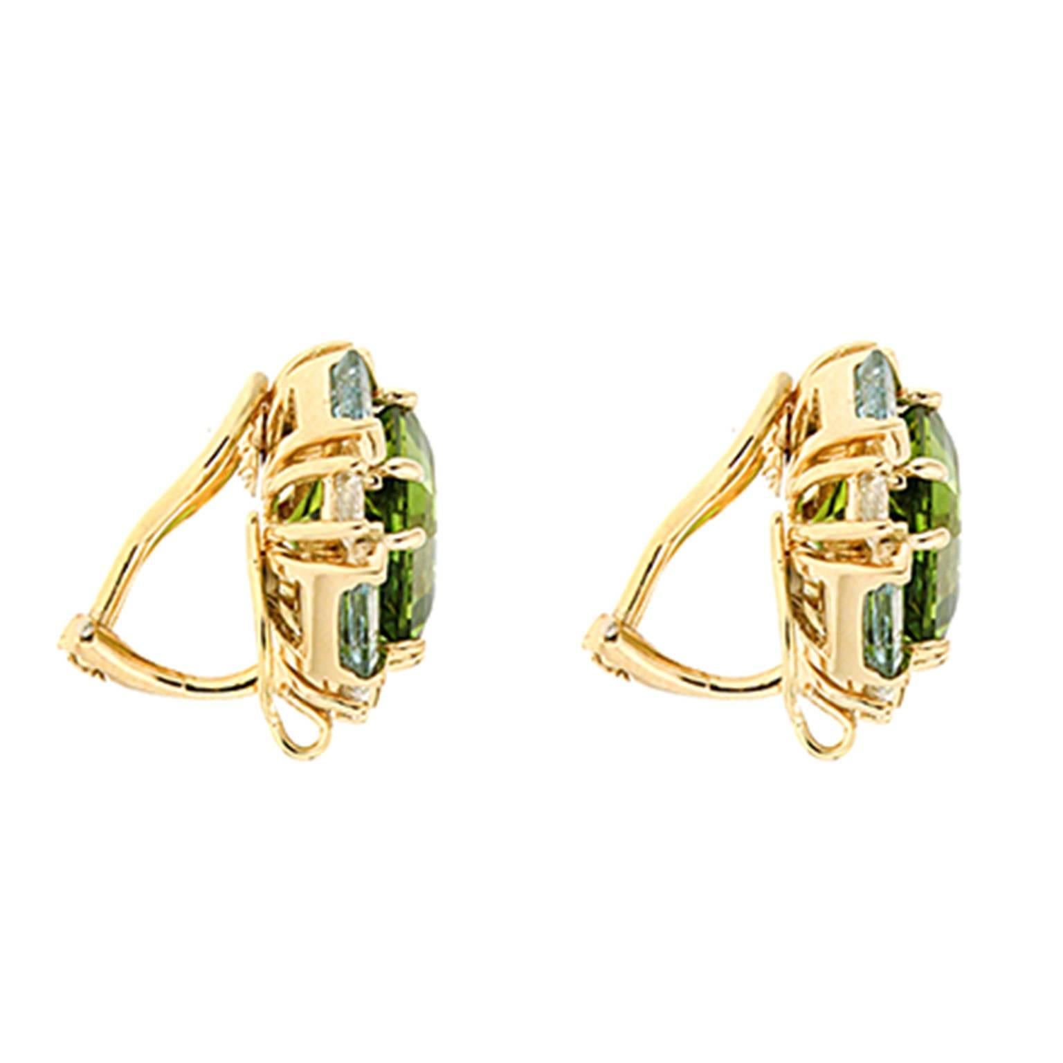 This lovely pair of earrings features expert selected special cut Octagon Peridot with Emerald Cut Aquamarines and Round brilliant diamonds. The earrings are completed in 18kt yellow gold with clip backs. Posts can be added upon request.