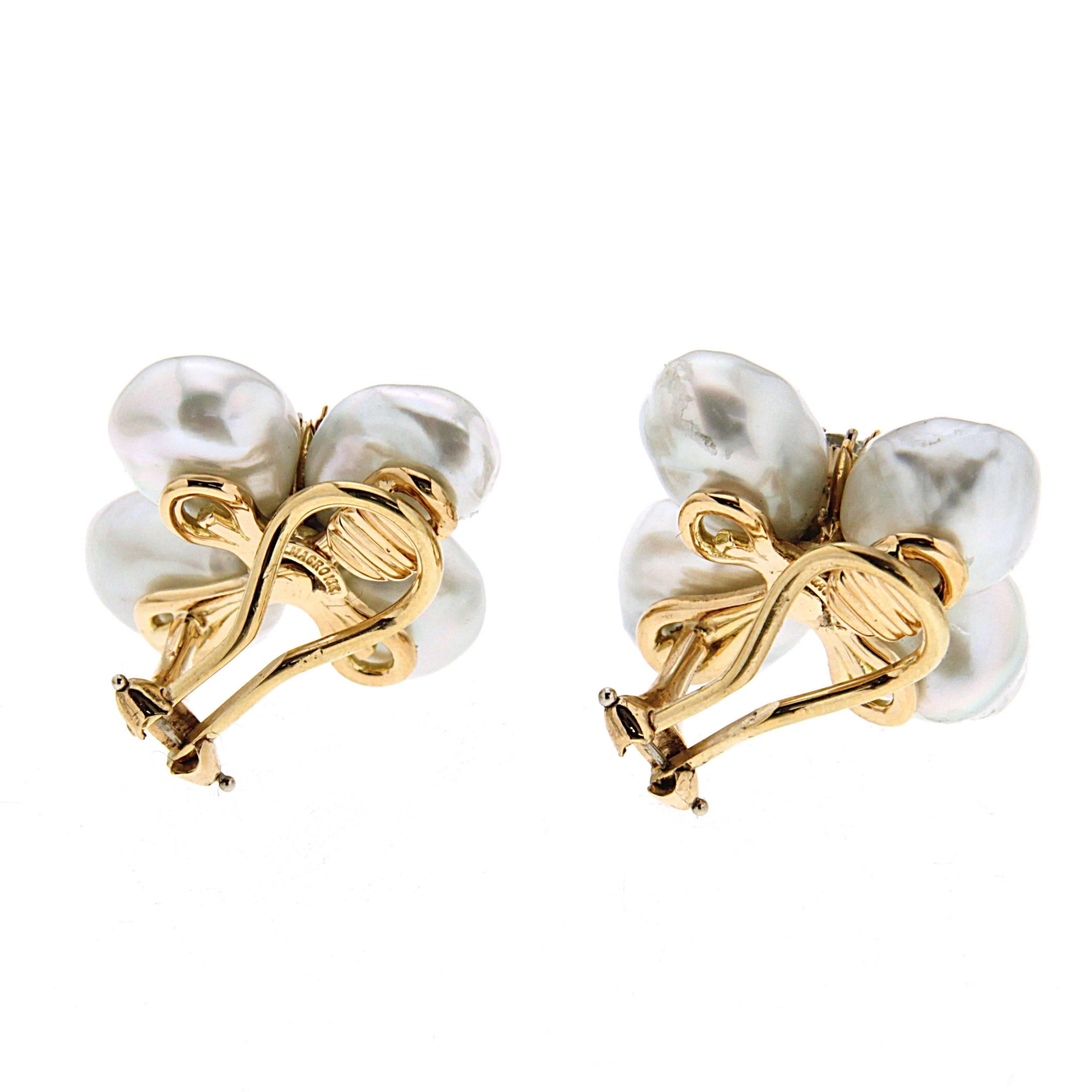 This lovely pair of earrings features cluster White Baroque Keshi Pearls with diamonds in the center. The earrings are finished in 18kt yellow gold with clip backs.  

Diamonds total weight 0.86ctw