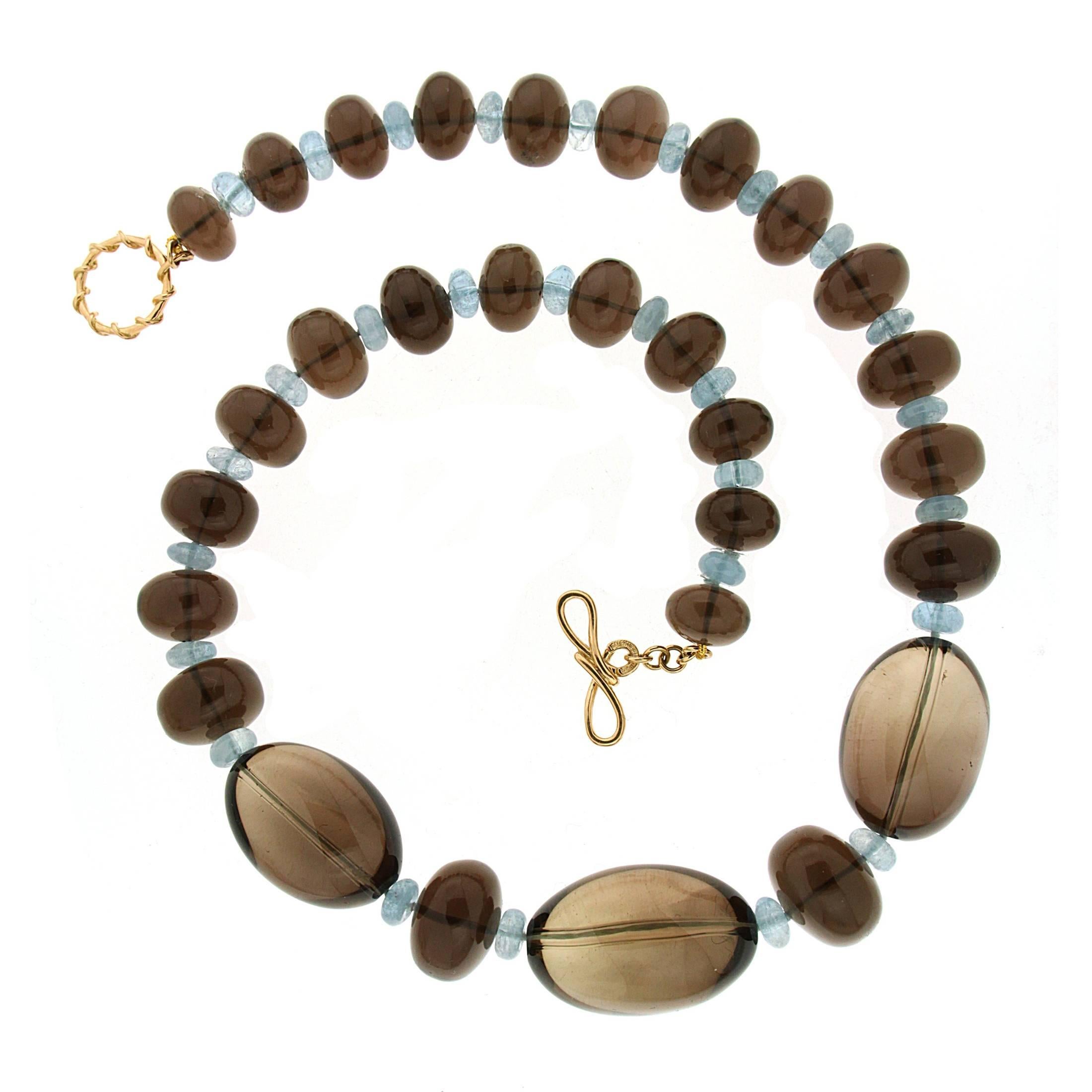 For decades, Valentin Magro's fine jewelry creations have illuminated the most special of occasions. This unique necklace features brown Topaz rondelles and large oval bead with aquamarine rondelles decorated in between. The necklace is finished