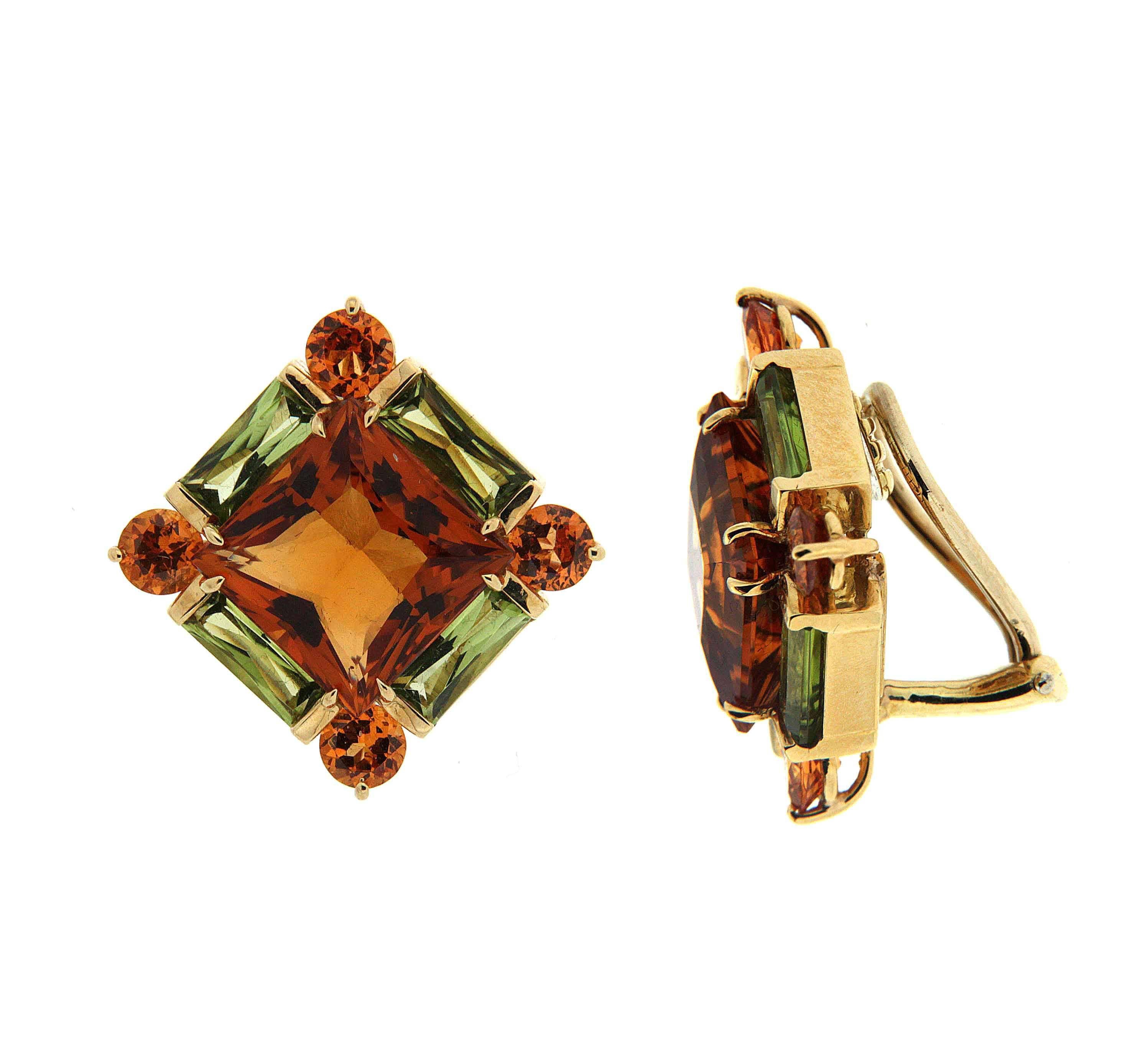 This lovely pair of earrings feature princess cut Citrines and Peridot Baguettes and round citrines on the side. The earrings are finished in 18kt yellow gold with clip backs.