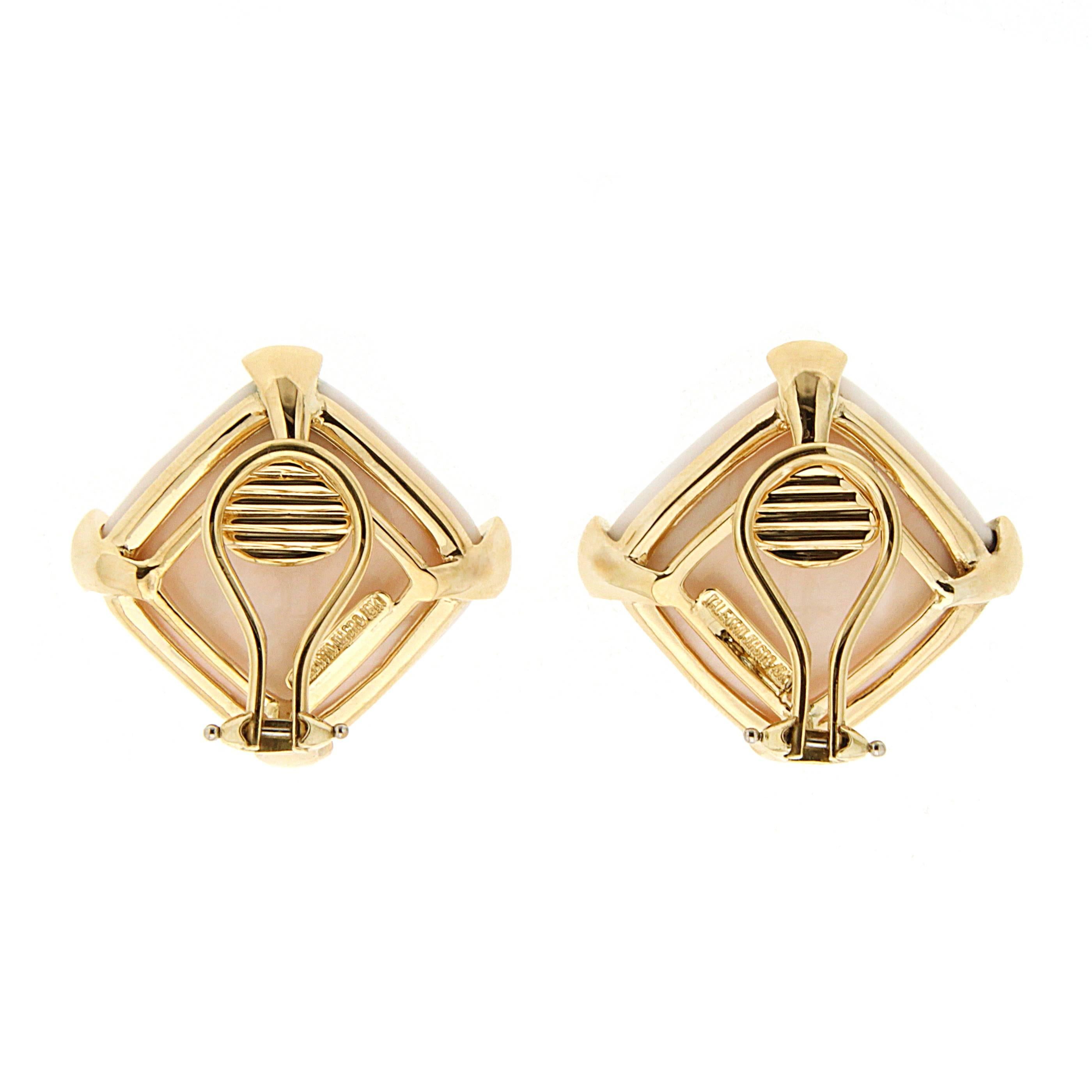 This lovely pair of earrings feature Cushion white coral (20mm) button earrings decorated with triangular claws on sides in 18kt yellow gold with Clip Backs.  