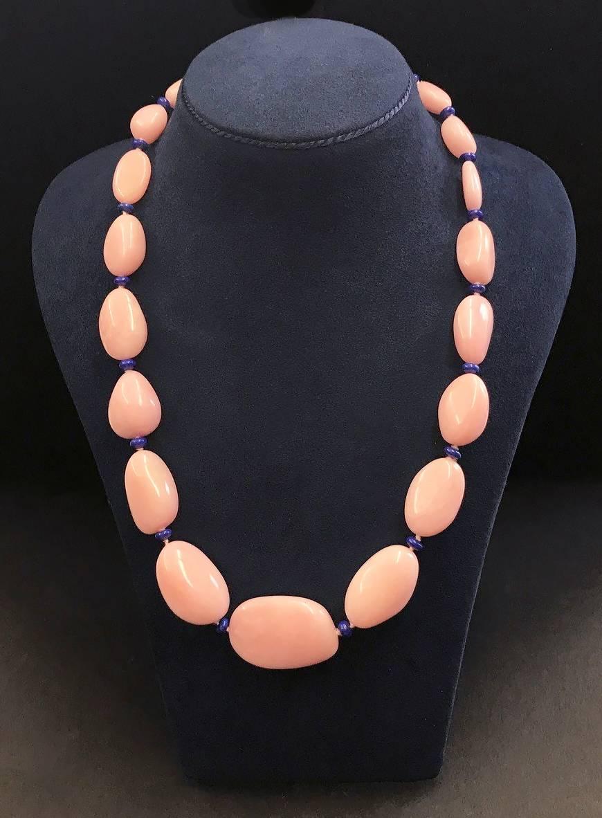 This lovely pink Peruvian opal with lapis rondelles necklace features in 18kt gold with ring and toggle clasp. 