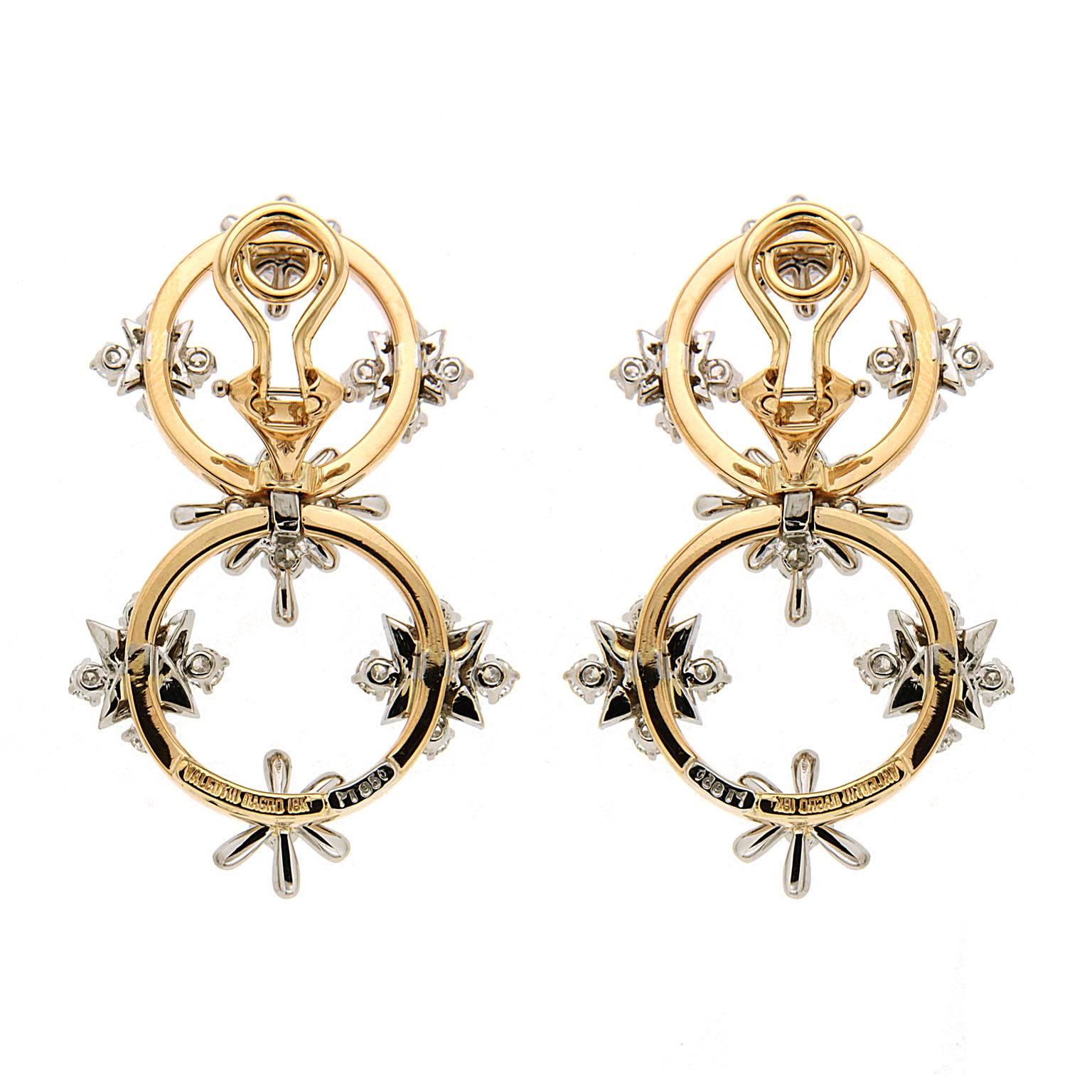 This unique pair of earrings features two circle links with diamonds and floral / star motifs conveys an airy feeling. The earrings are completed in 18kt yellow gold and Platinum with clip backs. Matching bracelet is also available. 