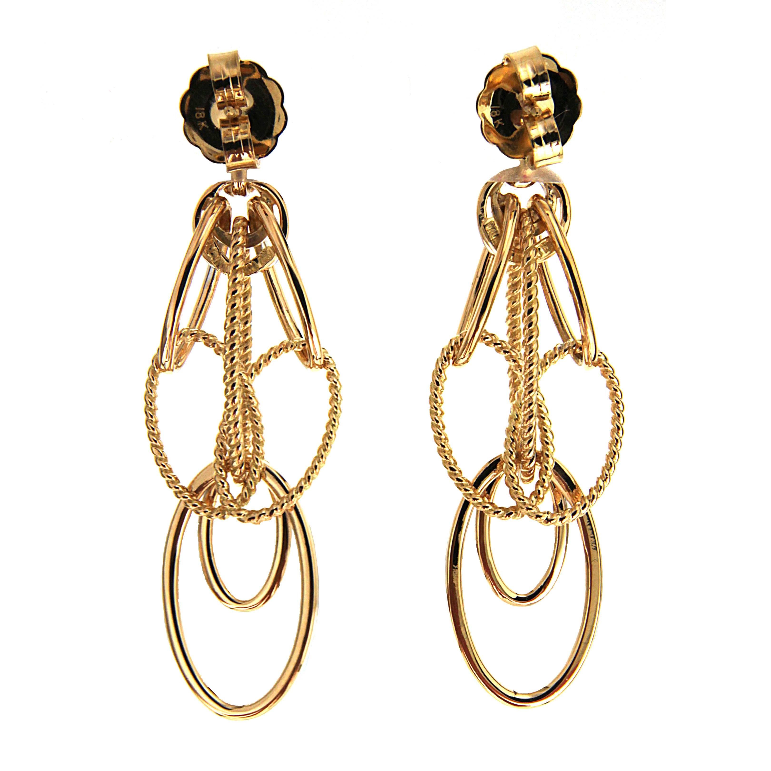 This unique pair of Cascading Oval Twisted and Plain Wire Earrings is designed with diamonds on the hoops, double circles and lower large oval. The earrings are finished in 18kt yellow gold with posts. This is a smaller version.

Large version also