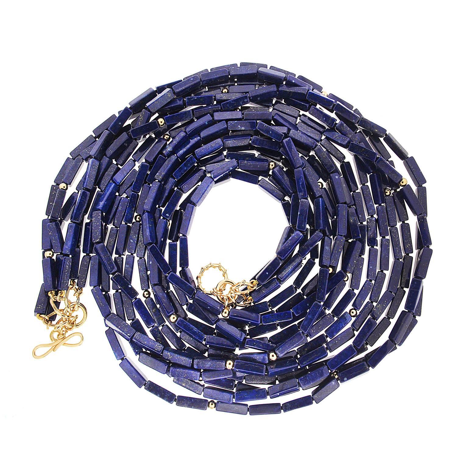 This necklace features five strands of elongated Lapis Lazuli cubes with gold balls. The necklace is finished with medium wire knot and  wire link toggle in 18kt yellow gold. 