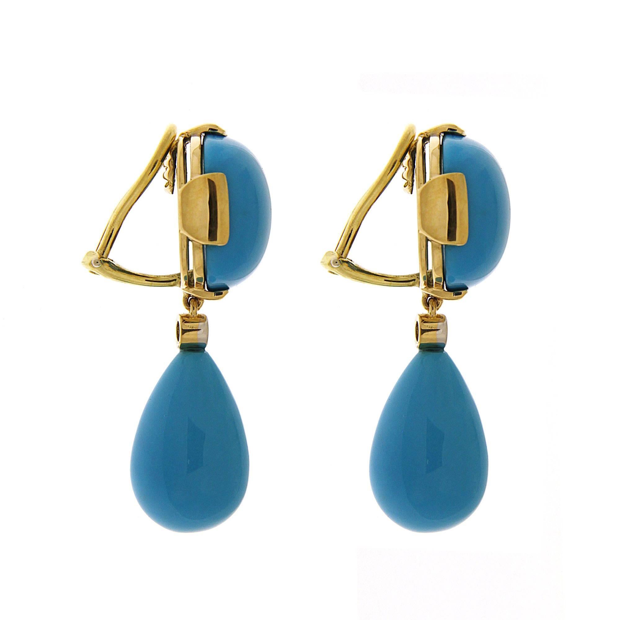 One of the most iconid designs, this lovely pair of earrings features cushion cut Turquoise cabochon and Turquoise drops in 18kt yellow gold with bezel set diamond connectors. The earrings are finished with clip backs. 