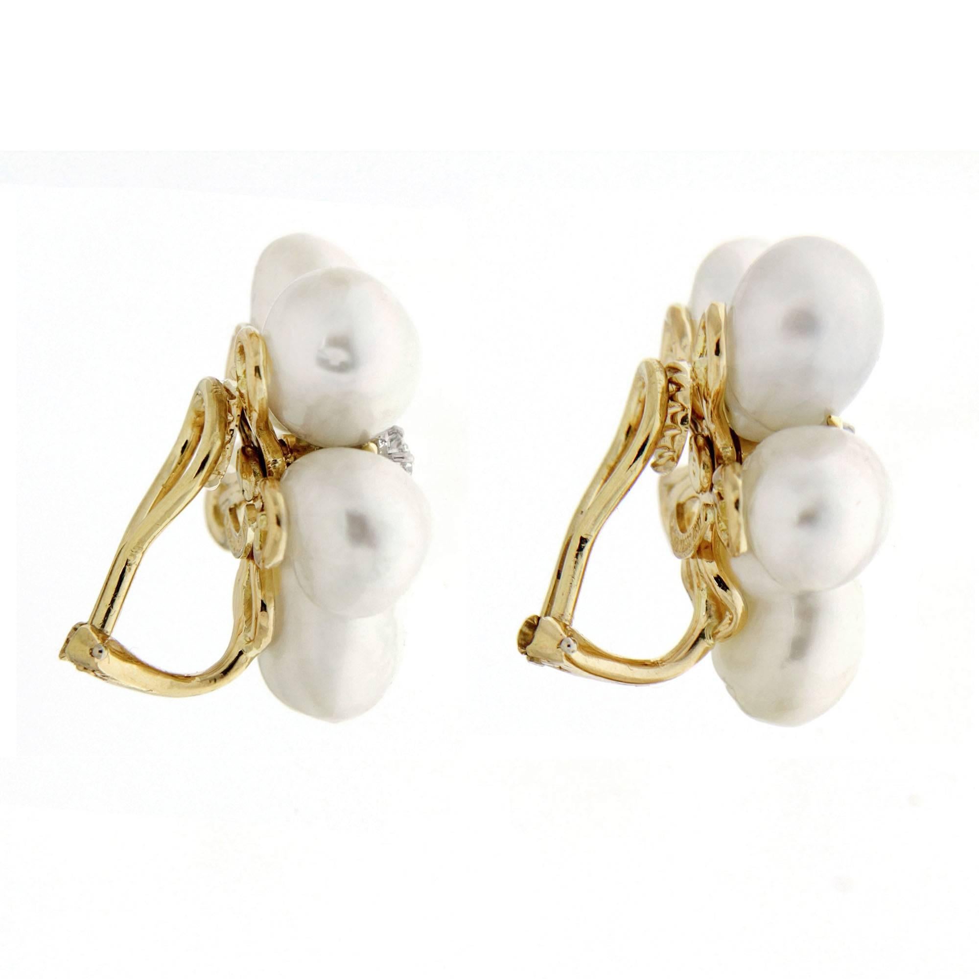 Pearls become these earrings’ petals. Each earring has five oblong keshi pearls clustered together, forming a flower. Six round brilliant cut diamonds form a blossom’s center, while 18k yellow gold adds color. The 10 keshi pearls measure 9.8 by 9mm.