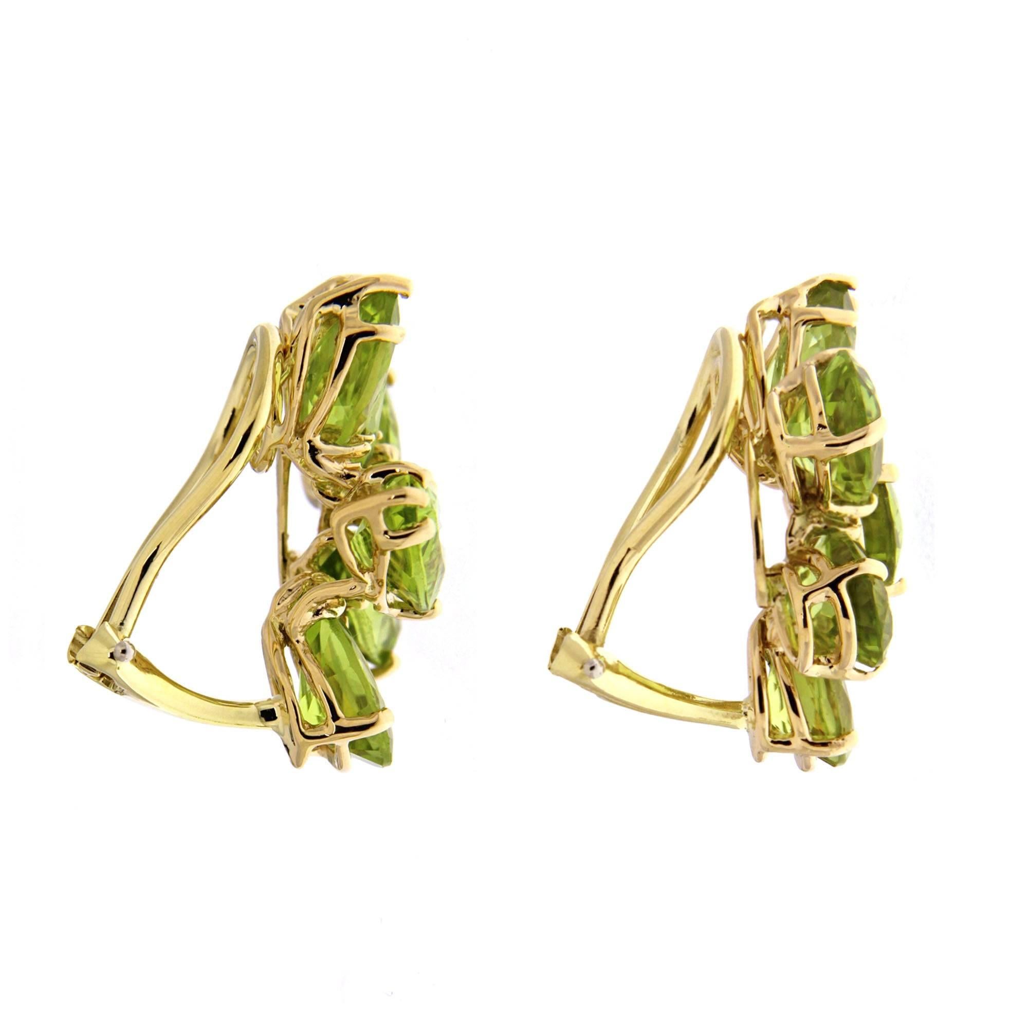 One of the most unique jewelry designs, this lovely pair of earrings features cluster of pear shape and marquise cut peridots selected and matched perfectly by our gem expert . The earrings are finished in 18kt yellow gold with clip backs. The