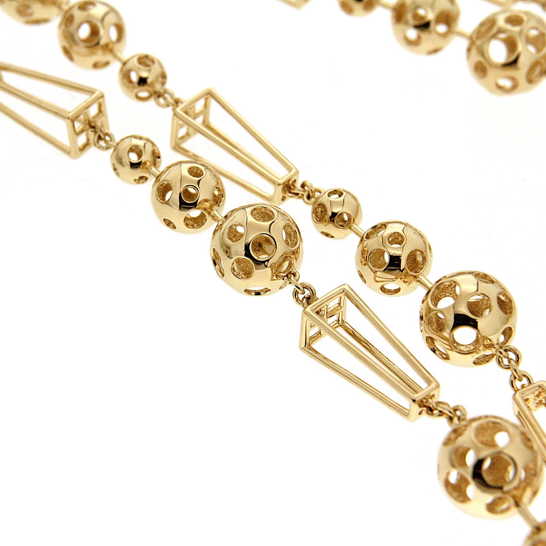 For decades, Valentin Magro's fine jewelry creations have illuminated the most special of occasions. This unique necklace features 16 units of planet orbits ball with a trapezoid shape wire frame. The necklace is completed in 18kt yellow gold with