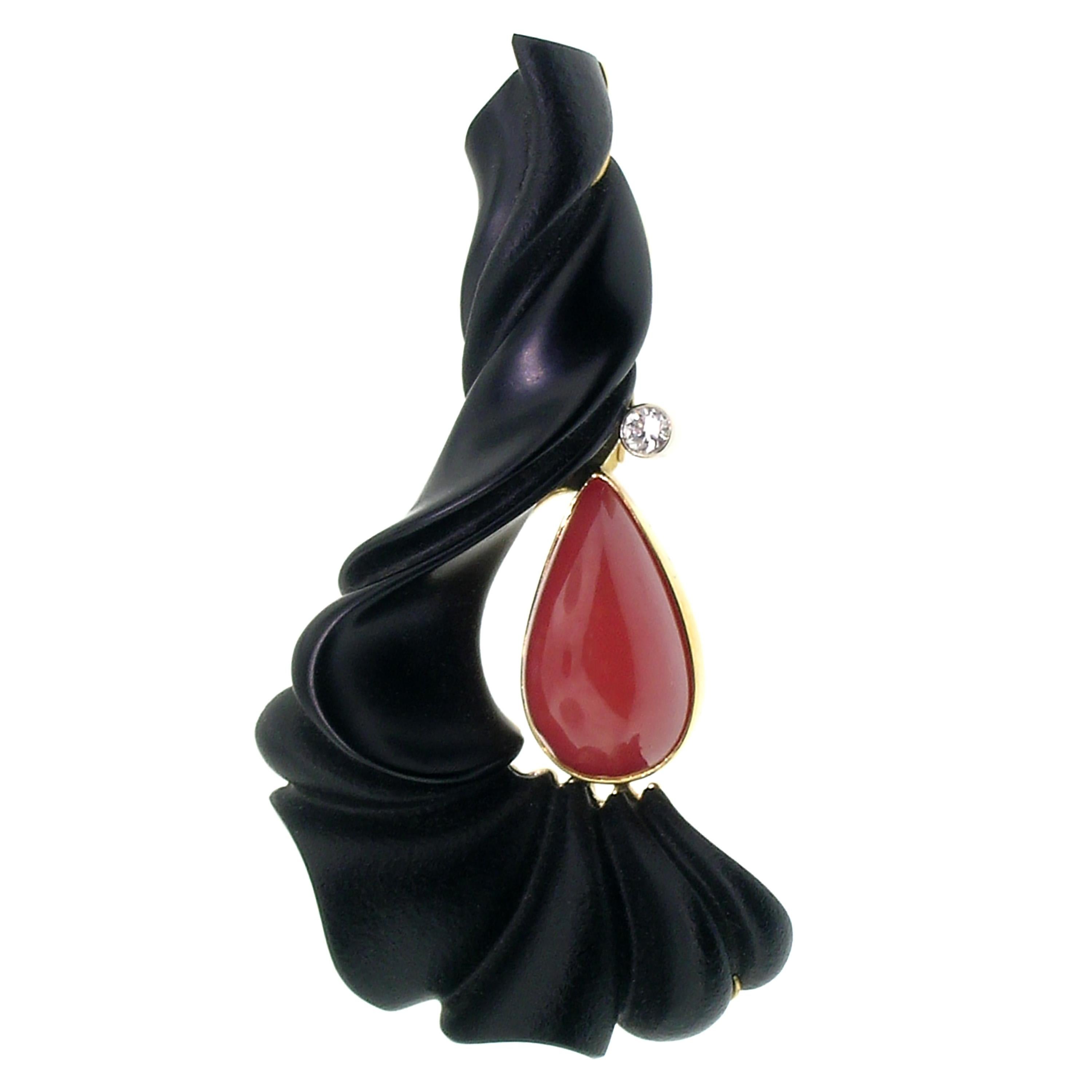 This gorgeous ruffle of natural black chalcedony was perfectly carved by lapidary artist Steve Walters. The ruffle wraps around a pear shaped pink bustamite, an exceedingly rare and beautiful gemstone. This piece is finished perfectly with a single