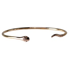 Bracelet jonc serpent en or, diamants blancs et rubis