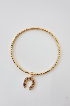 Ruby Horseshoe Charm Twisted Gold Bangle Bracelet