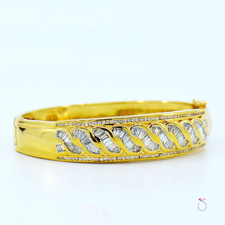 Beautiful Diamond Bangle Bracelet in 18K yellow gold with 2.48 carats of fine round brilliant & Baguette cut diamonds. This hinged bangle features 82 round brilliant cut diamonds & 83 baguette diamonds that are beautifully matched for color and