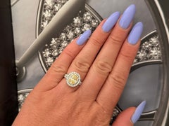 Natural Fancy Yellow Oval Diamond Halo Ring, 1.60 Carat, 18 Karat 2.34 Carat