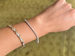 Bracelet « tennis » à diamants ronds serrés par trois griffes, en or blanc 14 carats