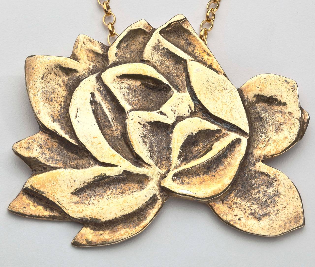 A striking flower pendant/brooch in gilt metal by Lowell Nesbitt (Born Baltimore 1933- Died 1993).  Nesbitt was a highly celebrated American artist of the Photo Realist movement of the 1960's-1970's.  He was also considered part of the Pop Art