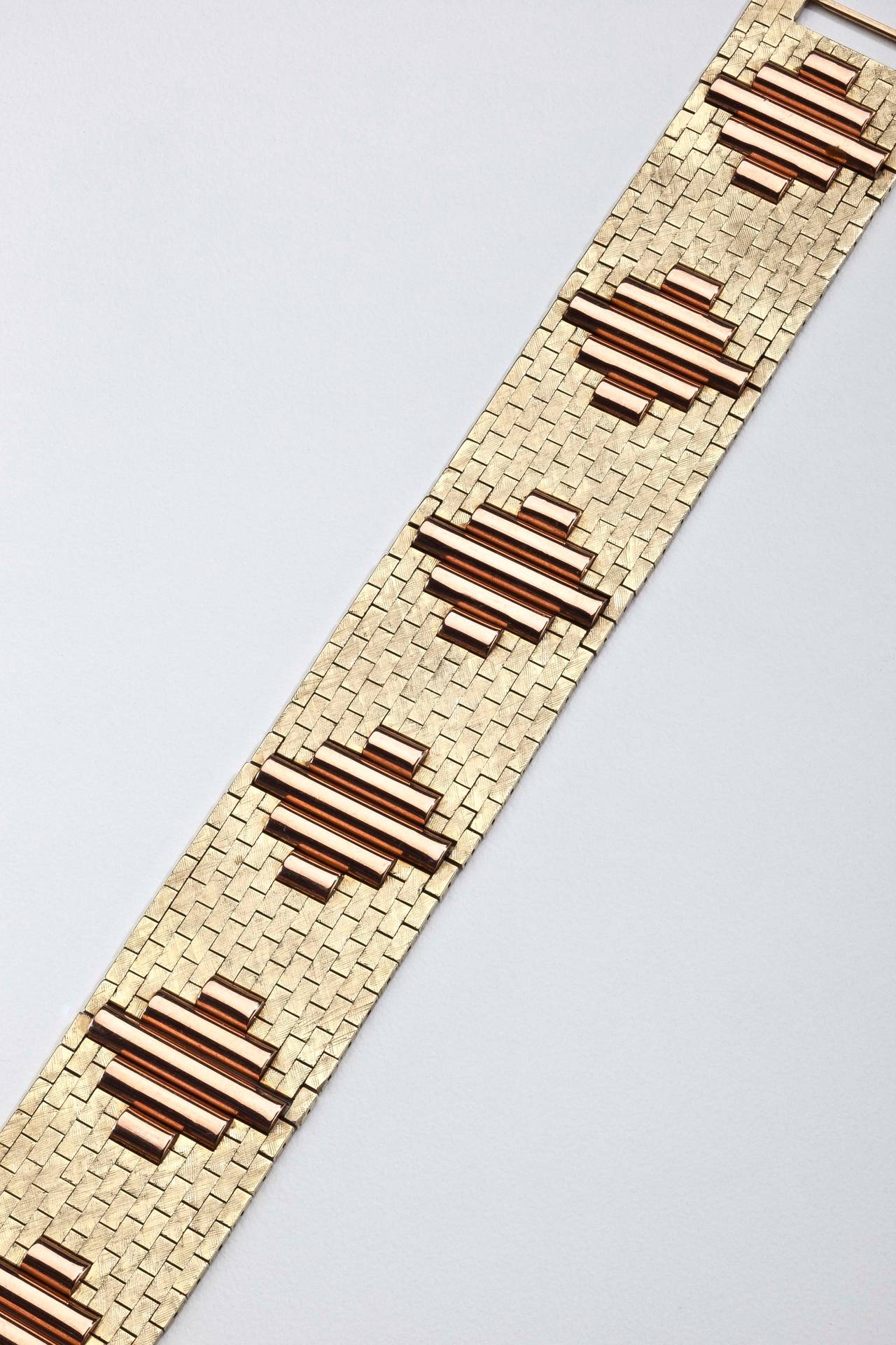 A 14 karat gold bracelet from the 1940's by Tiffany.  The bracelet is highlighted by a brick and column design in alternating patterns of yellow gold and pink gold with a textured finish.  Signed Tiffany & Co,14K on clasp.