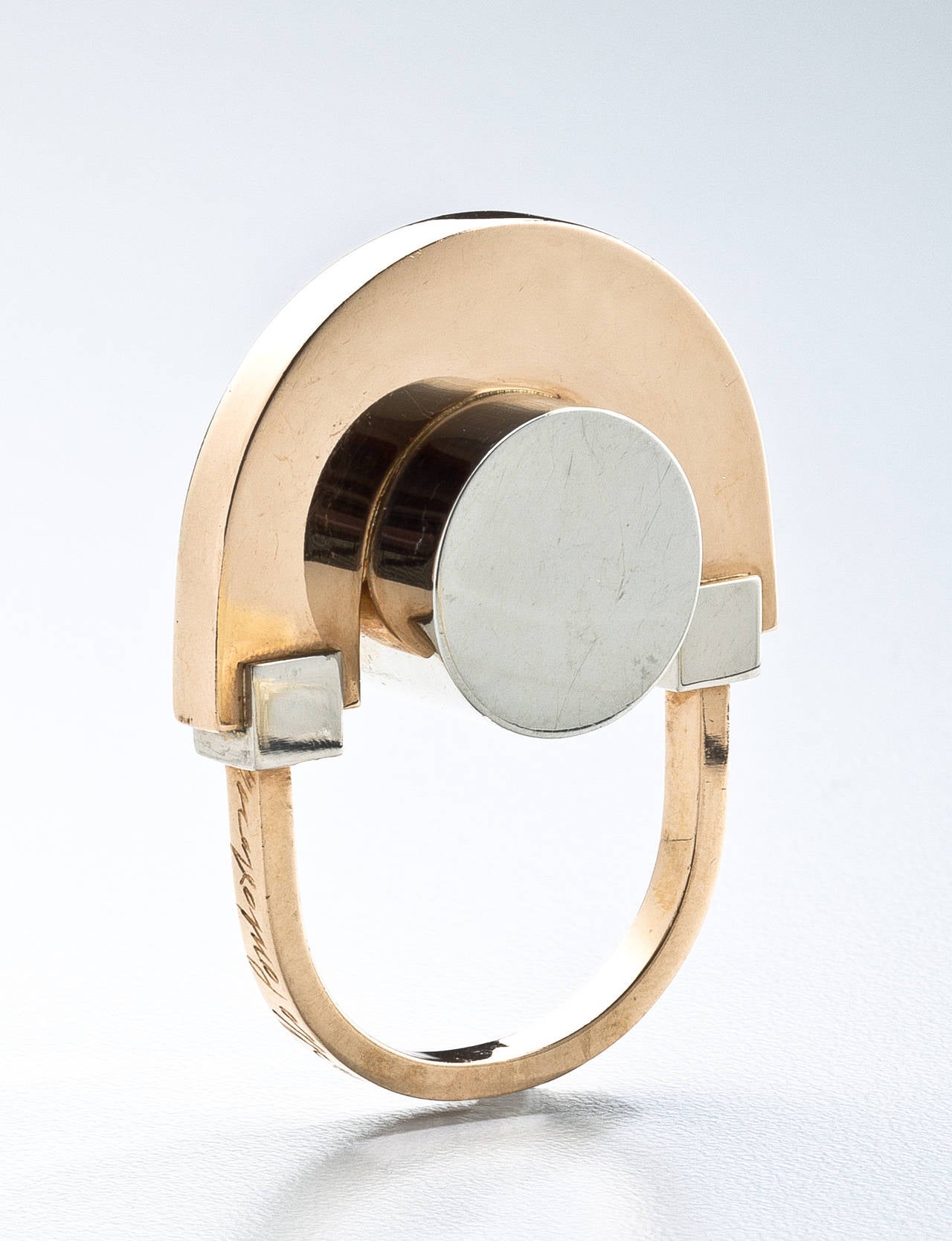 A dynamic abstract ring by the Italian artist, Arnaldo Pomodoro (b.1926) in white and yellow 18 karat gold.   The ring was commissioned from Pomodoro in 1967 as part of the GEM collection of artist's jewelry executed in Milan, Italy.  This example