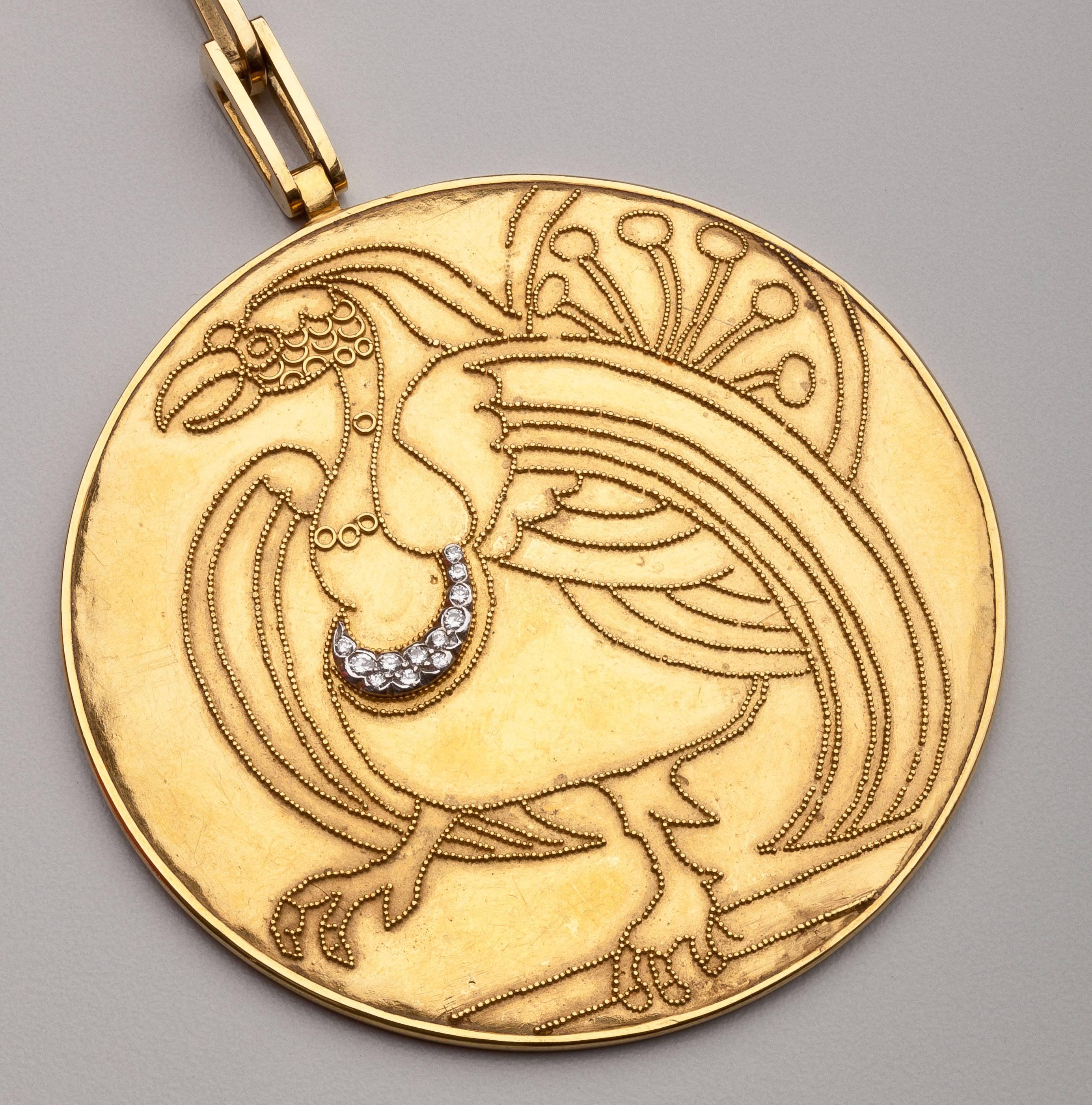 A rare high karat gold pendant by Wassily Kandinsky.  The gold pendant of a griffin is highlighted with nine prong set full cut diamond.  The griffin design is accentuated by Etruscan style granulation and tracery work culminating in a strutting