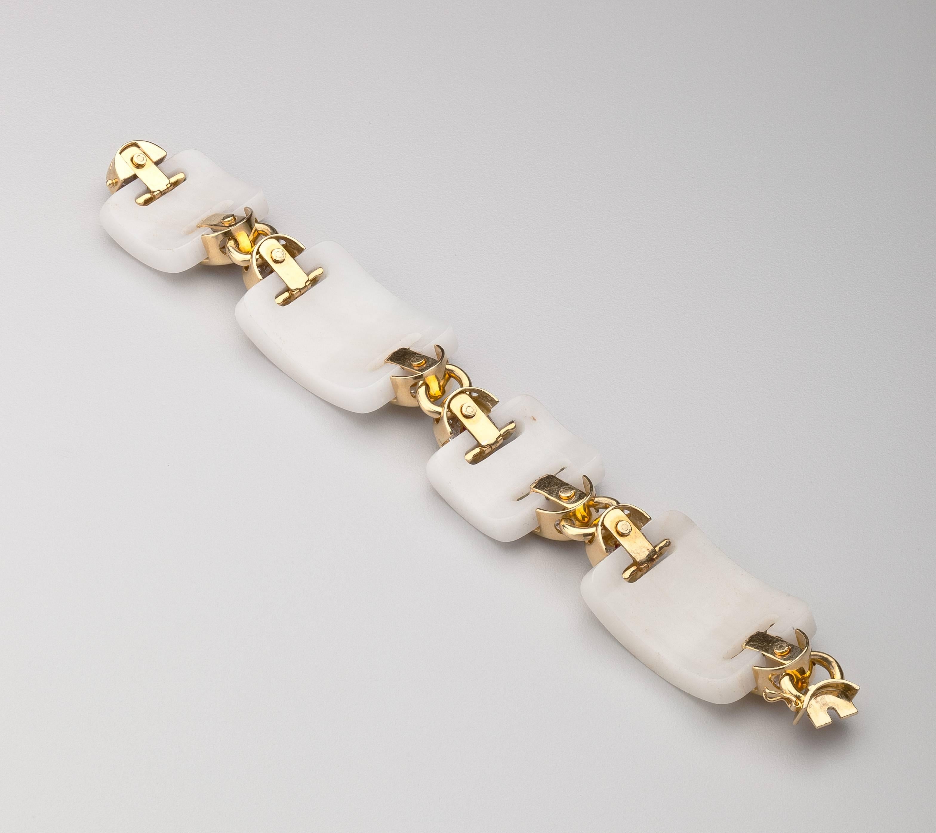 An 18 karat gold white onyx link bracelet with arched panels of onyx highlighted with diamonds and rubies. The eight rubies are beautifully matched cabochons, the 188 diamonds accent the white onyx. Unusual and very chic.  