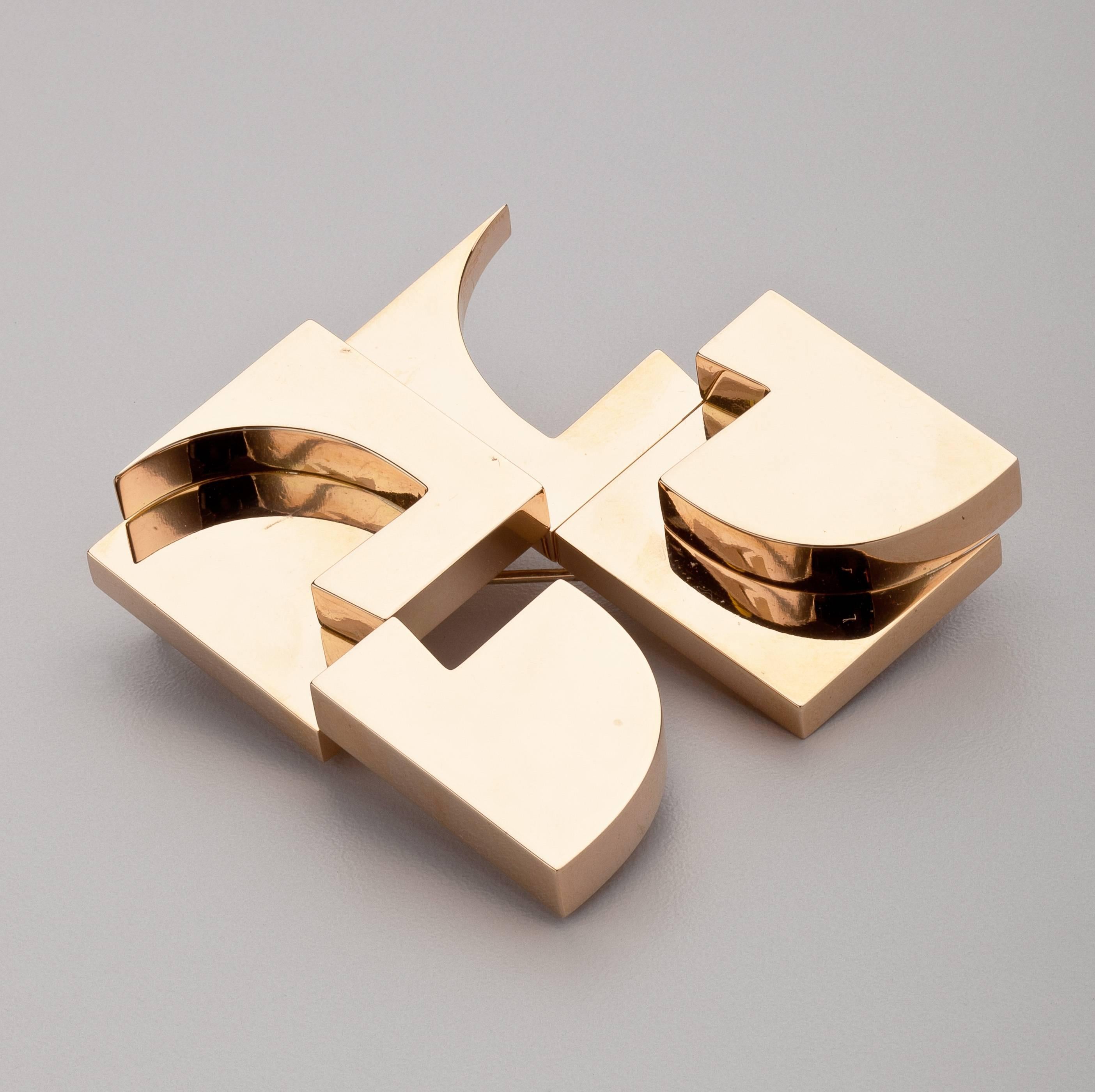 An abstract gold pendant/brooch by avant-garde artist Hans Richter (1888-1976).  This 18 karat gold pendant with a pin and suspension hook was designed by Richter in 1971 for GEM Montebello in Milan, Italy.  Its layered abstract geometric designs
