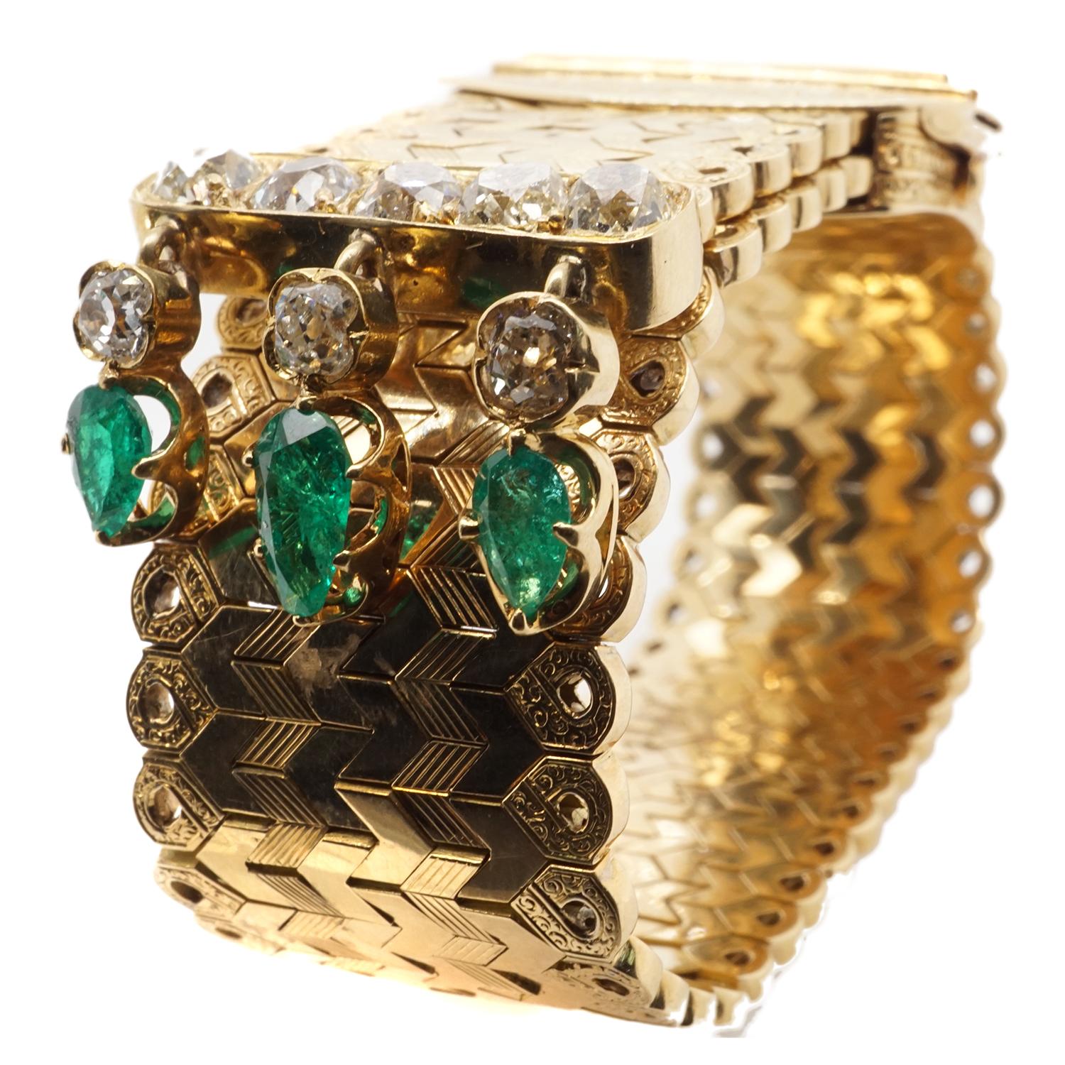 Crafted in 18 karat gold this slide bracelet features 8 old mine cut diamonds and 3 pear shape emeralds.  Measures 8 3/4 