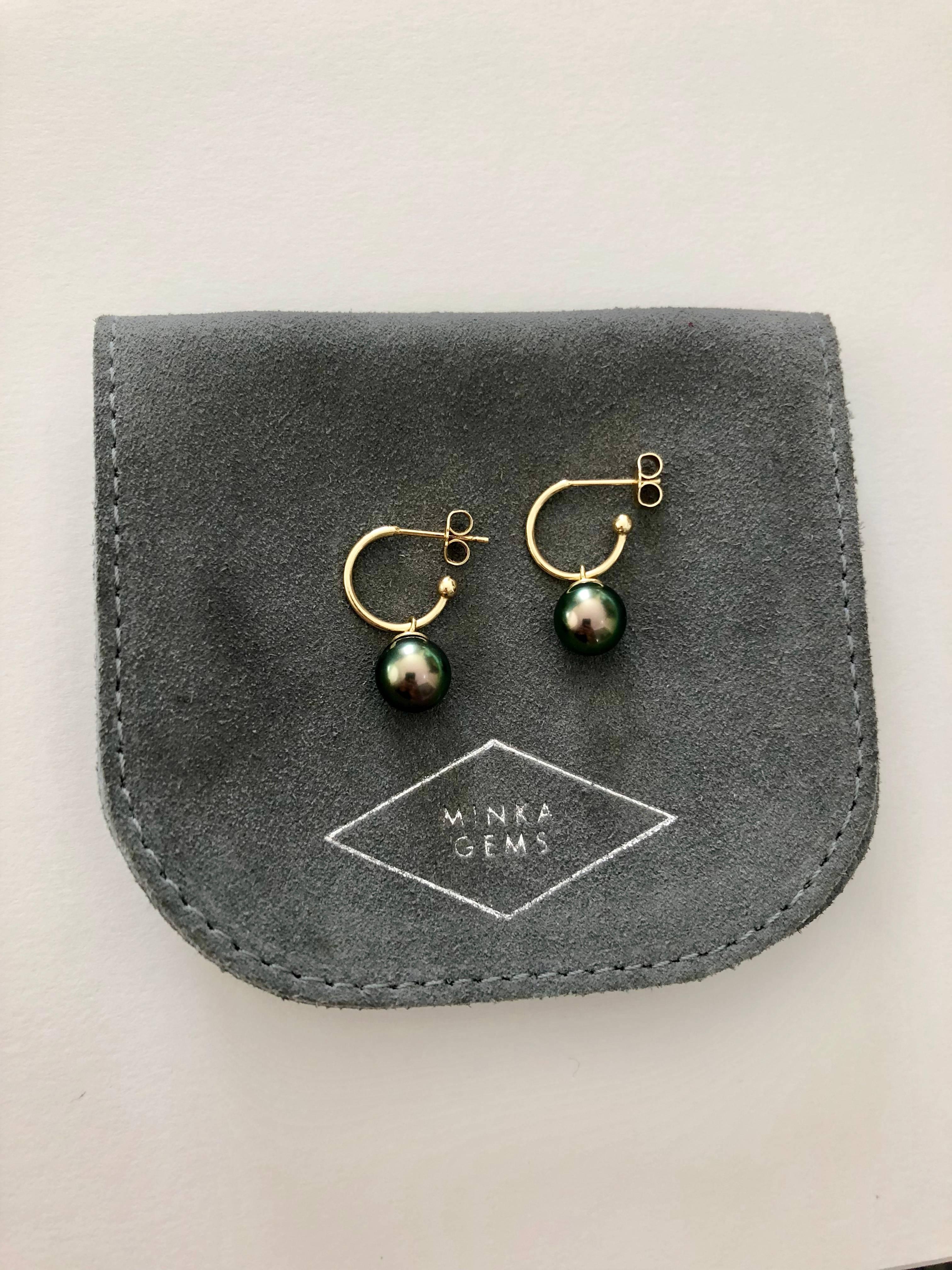 18 Karat gold hoops with removable Tahitian pearl drops. Everyone needs a pair of gold hoops, and to have a pair of Tahitian pearls to take the look one step further. Elegant and timeless this pair will soon be your favourite go to earrings.