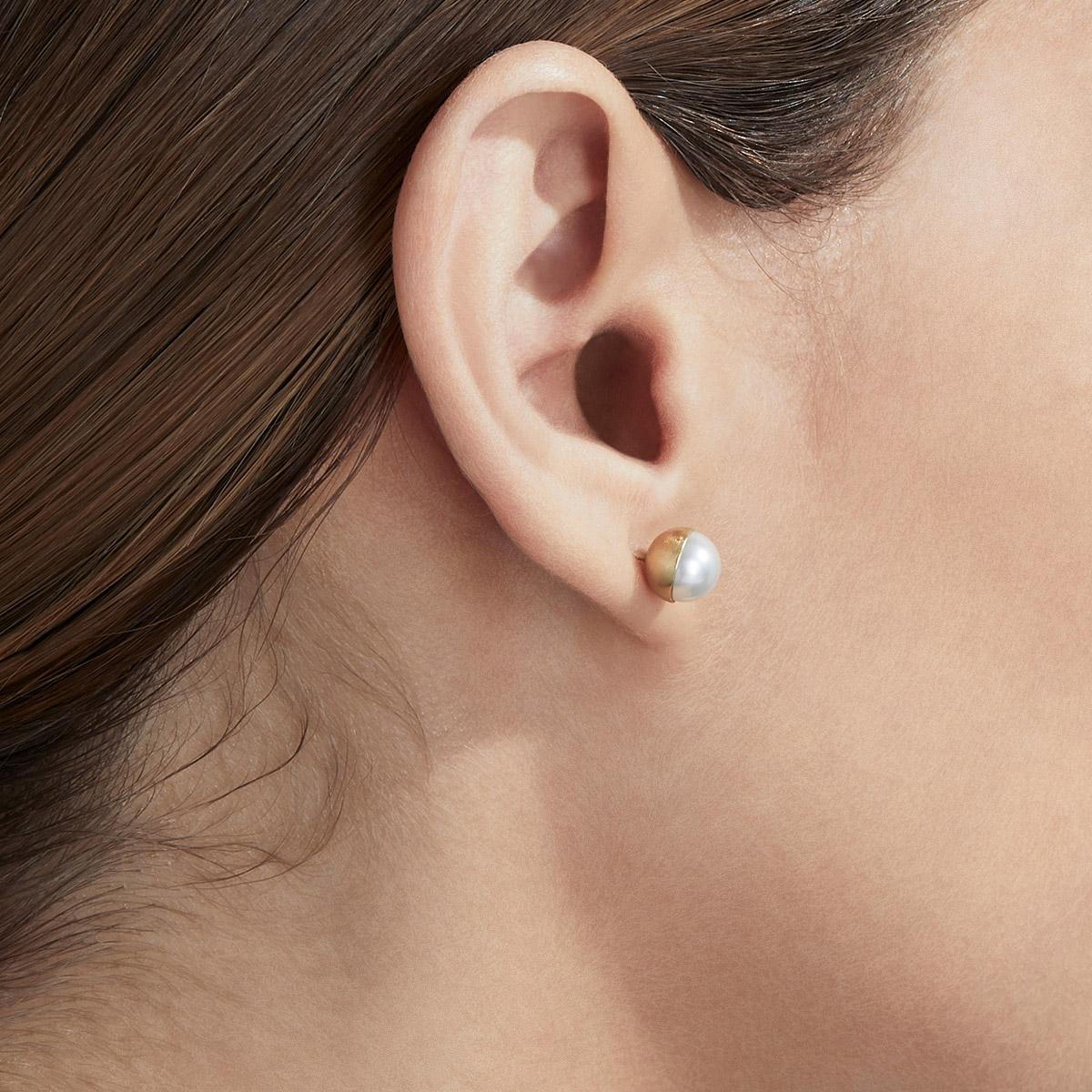 Akoya pearls are encased in a half sphere of gold at 0 and 135 degree angles and placed on a post. Each comes with an 18 karat yellow gold earring back. 

Post length: 11mm
Earring back length: 7mm
Akoya pearl: 7mm
This item is sold as a pair.
This