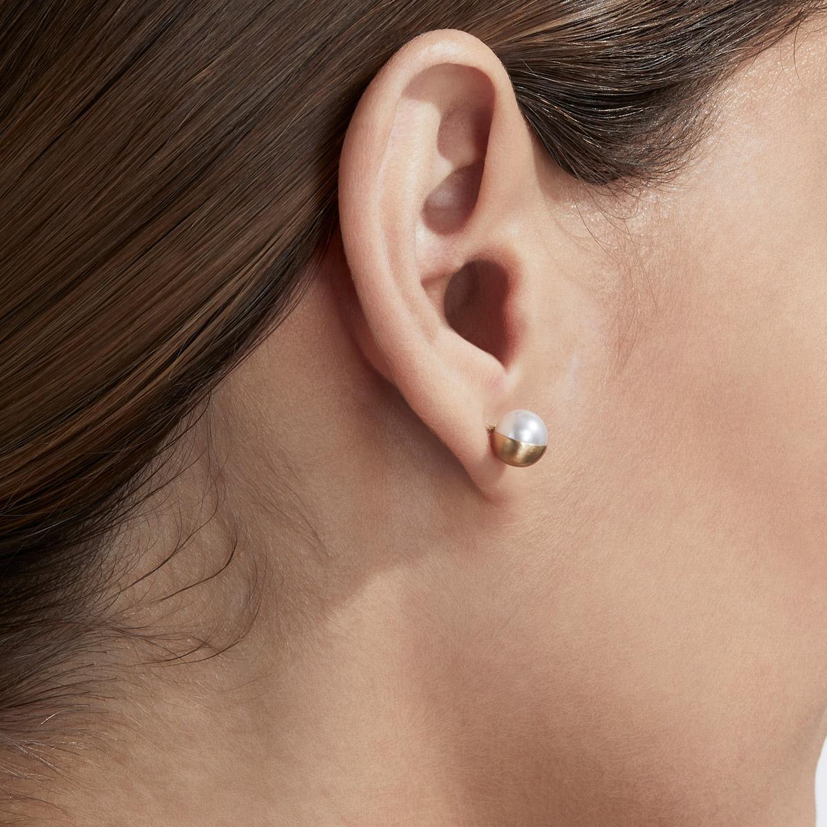 Akoya pearls are encased in a half sphere of gold at 90 and 135 degree angles and placed on a post. Each comes with an 18 karat yellow gold earring back. 

Post length: 11mm
Earring back length: 7mm
Akoya pearl: 7mm
This item is sold as a pair.
This