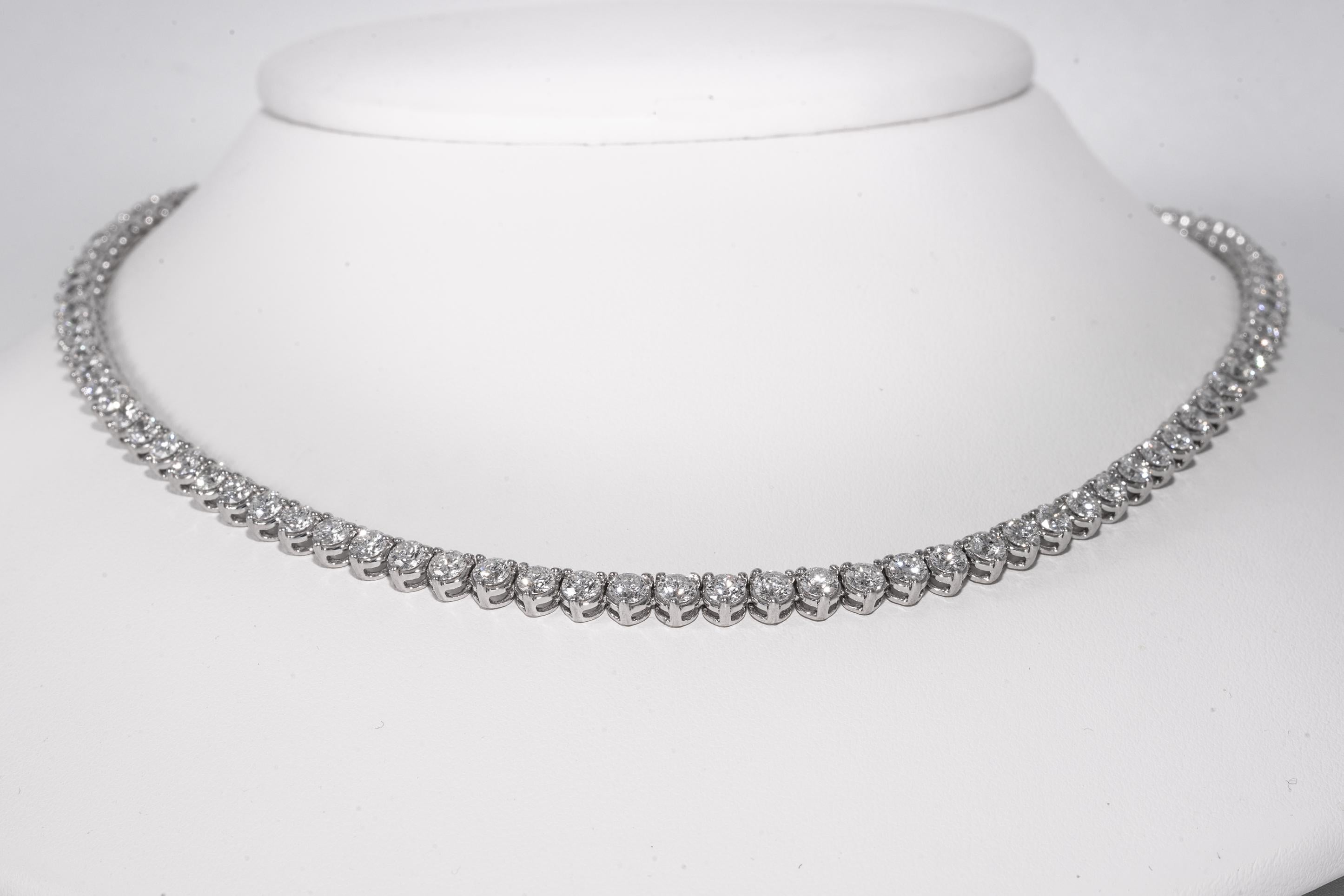 Classic Diamond Line necklace in 18 kt gold with 100 perfectly matched ( .13 ct each , 3.2 mm) 
round brilliant diamonds , with exceptional E color and SI2 clarity.  
Necklace is heavy weight , and exceptional craftsmanship.
Total carat weight of