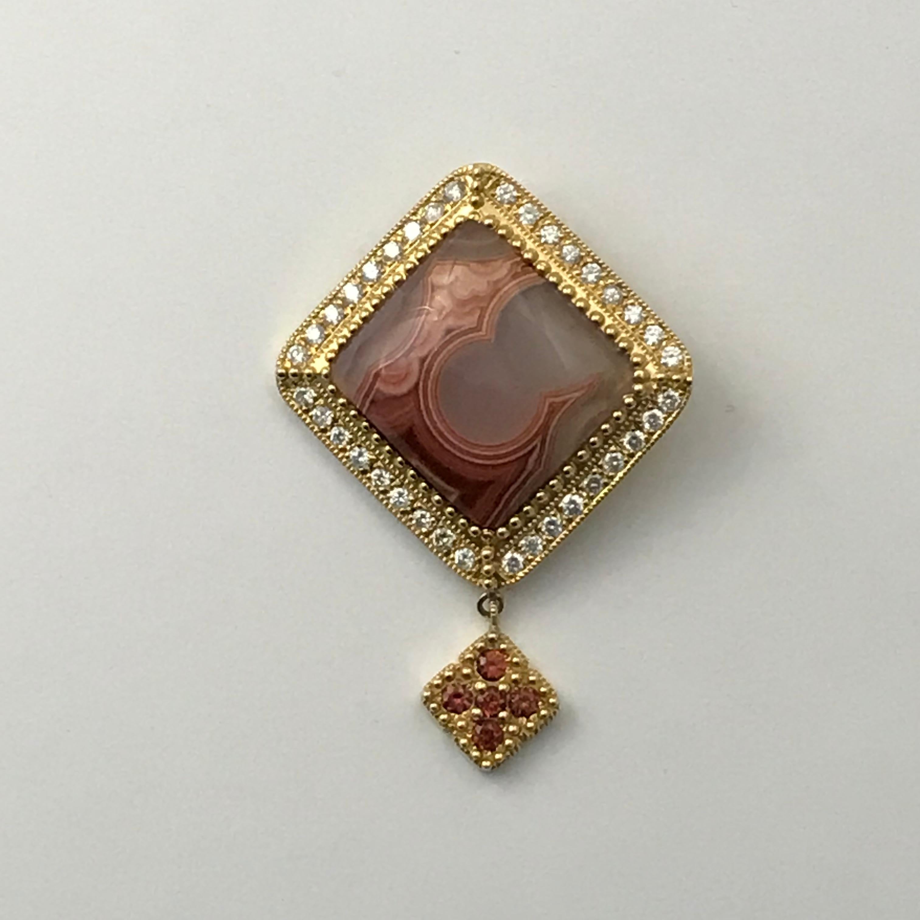 Lacuna Agate Pendant in 14K Gold & Diamonds
agate laguna pendant set in 14k yellow gold set with diamonds weighing 1.27 cts total and a dangle with spessartite garnets. 

Pendant is 35MM X 49MM