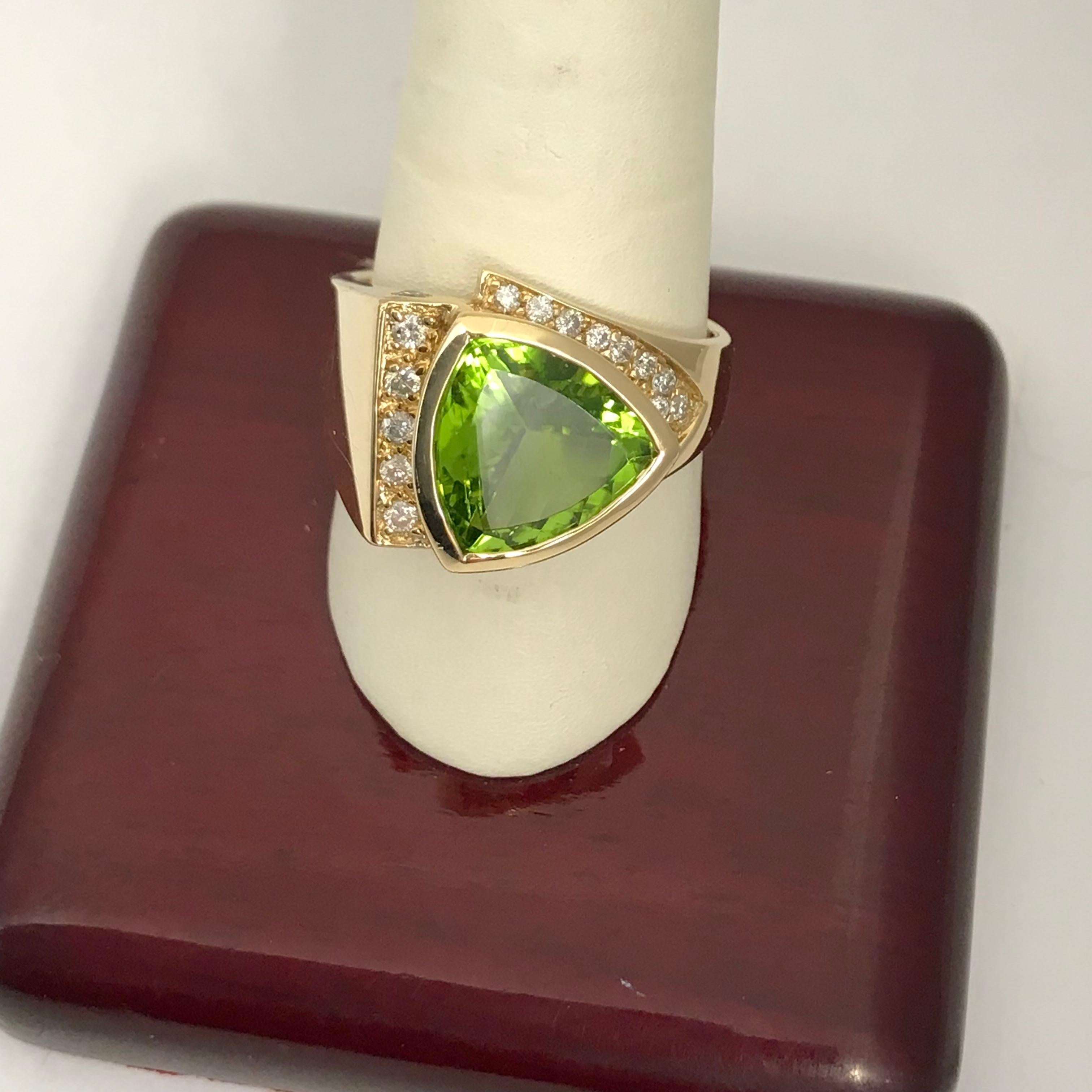5.11 Carat Peridot Ring in 14K Yellow Gold
This ring is made from 14k yellow gold and features a 5.11 ct Peridot and .46 cts total weight in Diamonds.  It is 100% natural in color nothing about it has been changed. Nature does some amazing things.