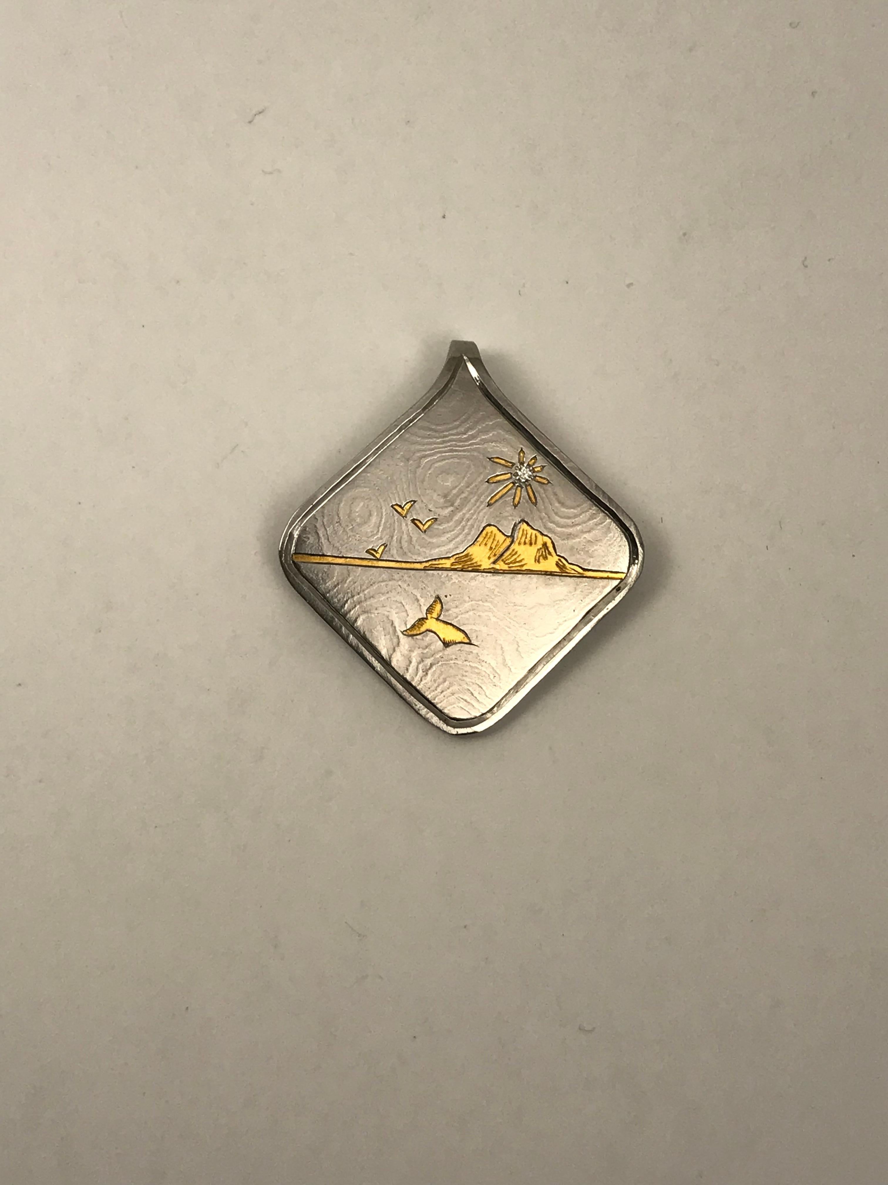 This is a beautiful pendant made of Damascus Steel with 24 karat gold inlays. This is difficult to do because I have to cut out the pattern into the steel then hammer a sheet of 24k gold into the shape then engrave the details. 

The gold will NOT