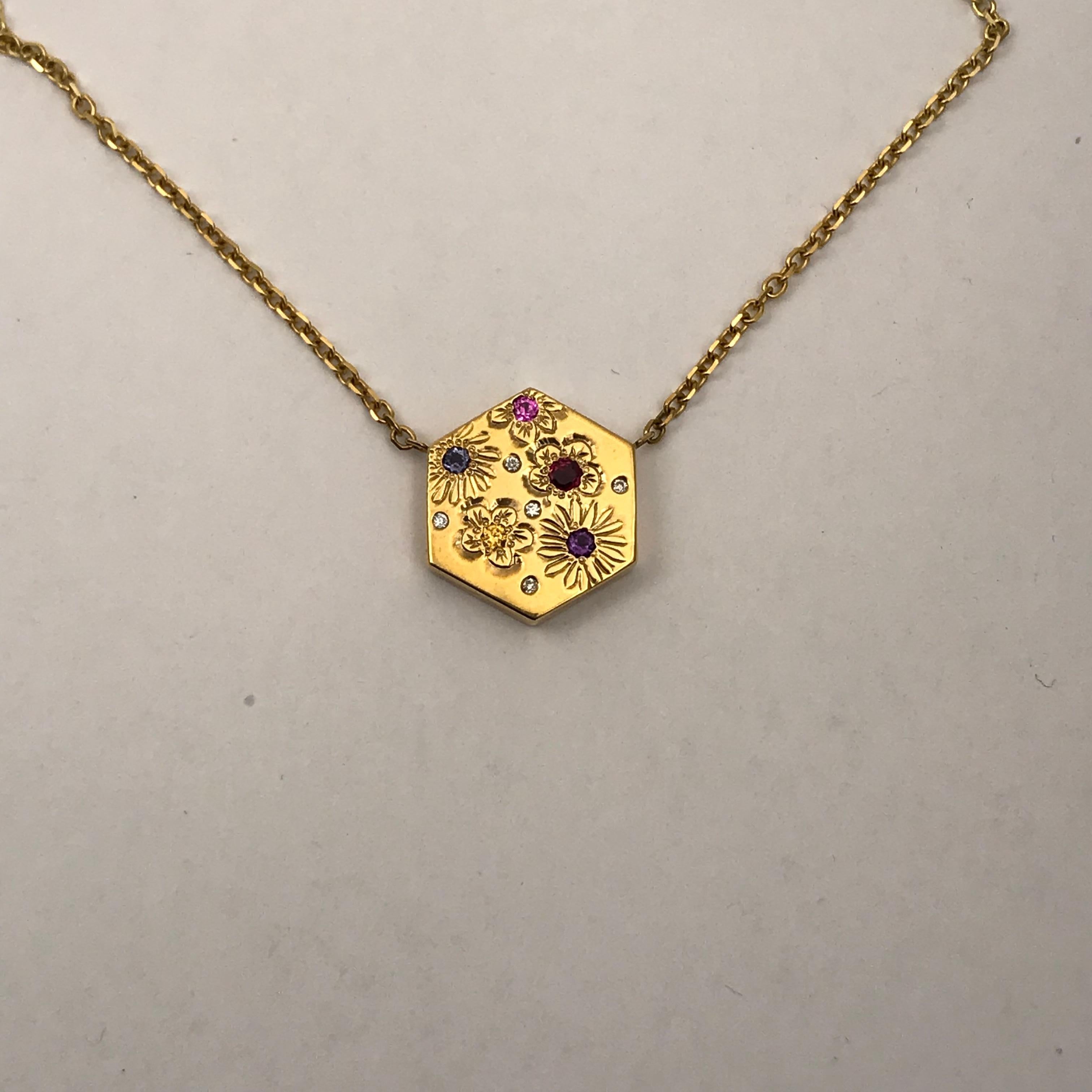 Hexagon Necklace in 14 Carat Gold & Gems-Flower Variety 

This is a one of a series of unique necklaces. Each one is hand engraved in different styles and different stones set.

This beautiful pendant is in the very trendy hexagon style and is set