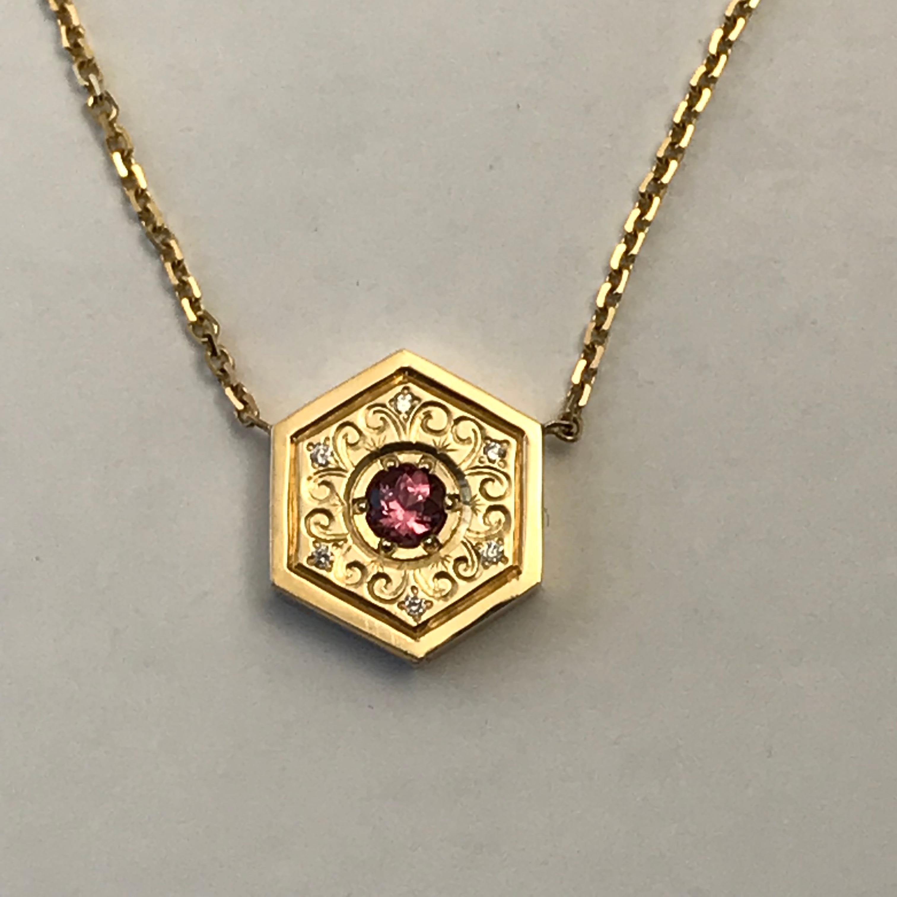 Hexagon Necklace in 14K Gold & Gems-Pink Sapphire Flower

This is a one of a series of unique necklaces. Each one is hand engraved in different styles and different gemstones. 

This beautiful pendant is in the very trendy hexagon style and is set