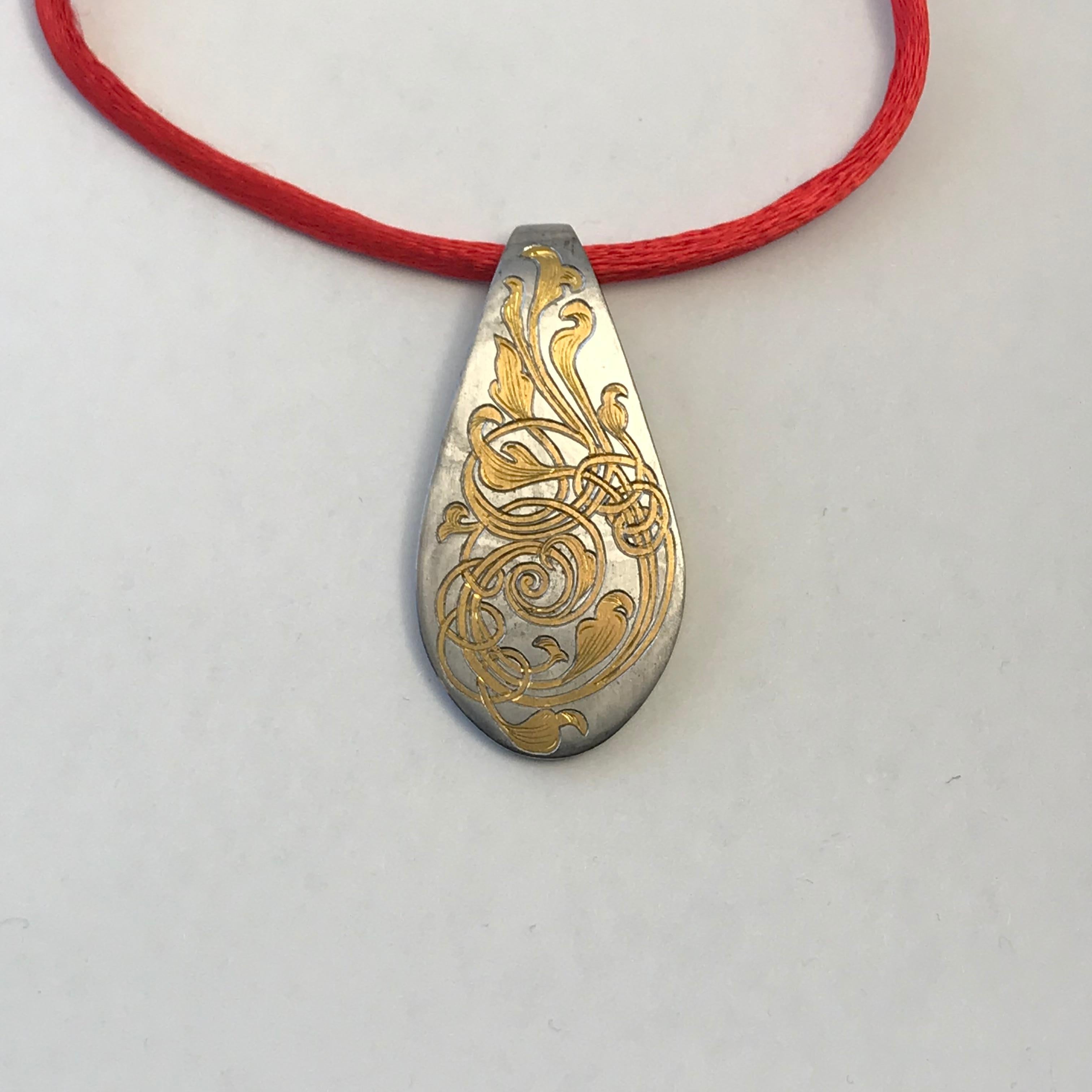 Damascus Steel & 24K Gold Pendant
This is a beautiful pendant made of Damascus Steel with 24 karat gold inlays. This is difficult to do because I have to cut out the pattern into the steel then hammer a sheet of 24k gold into the shape then engrave