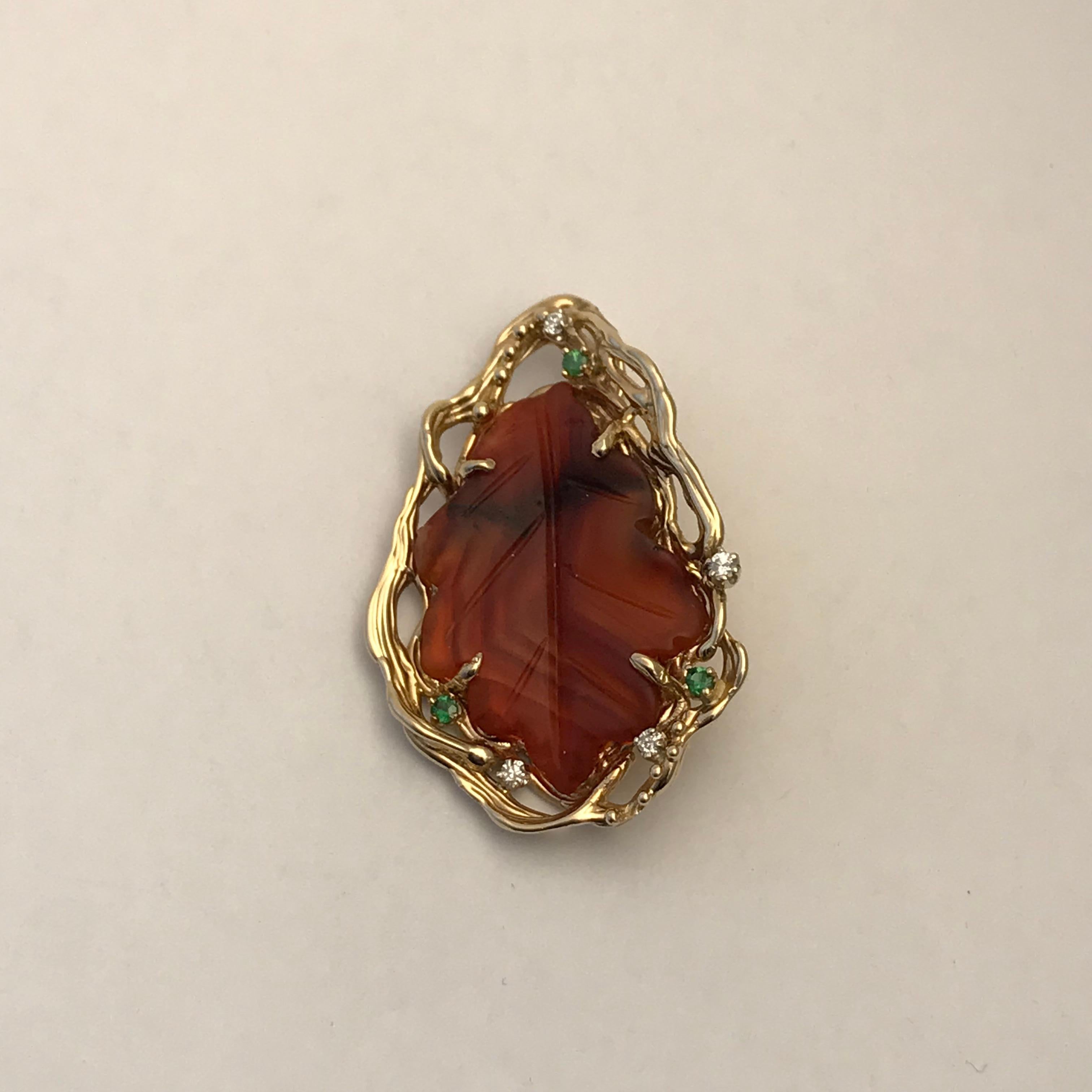 Lacuna Agate Leaf Pendant in 14 Karat Gold with Emeralds and Diamonds.

Agate Set with a free form design border in 14k yellow gold and accented with emeralds and diamonds

It is 100% natural in color nothing about it has been changed. Nature does