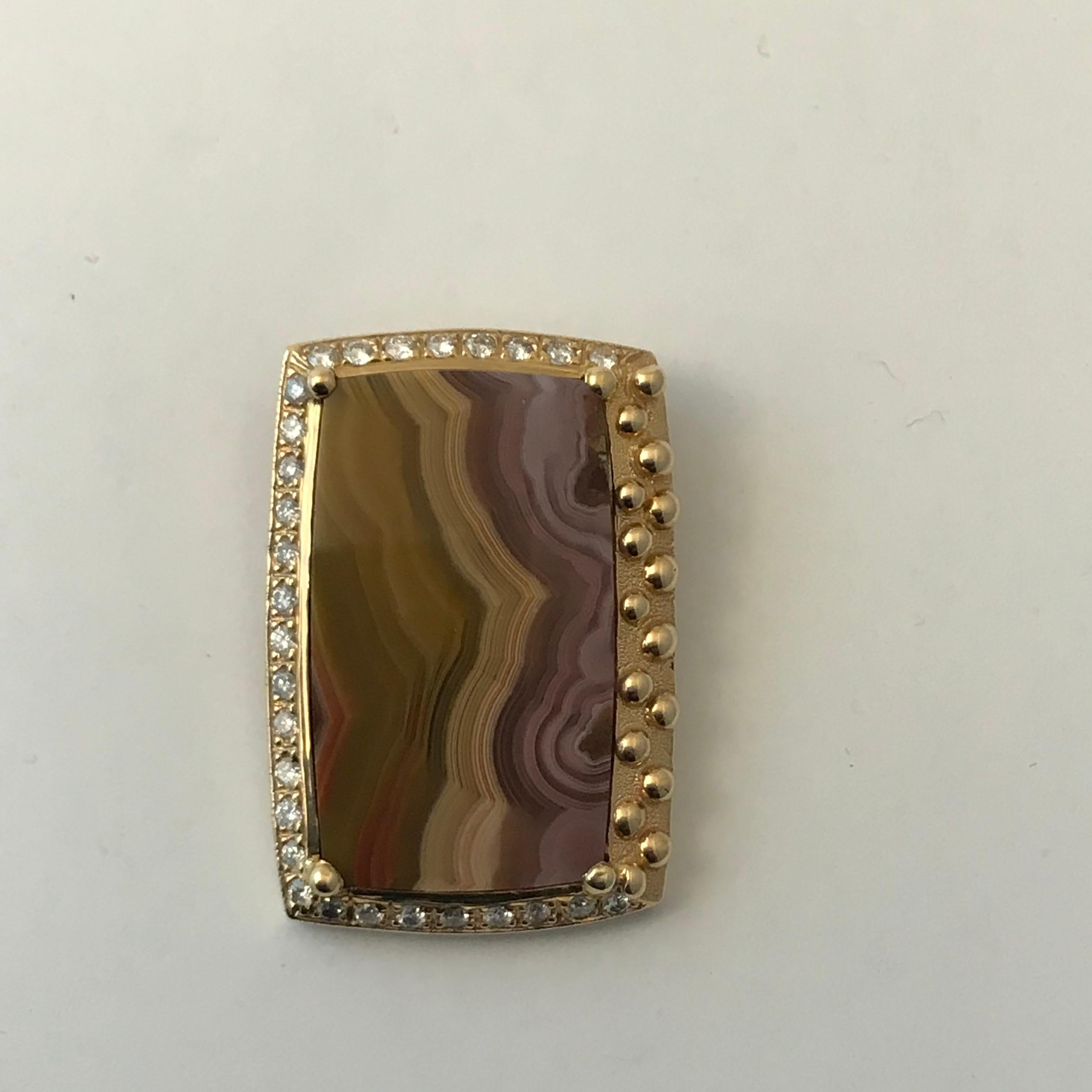 Laguna Agate Pendant with Diamonds in 14 Karat Yellow Gold

Purple and Brown laguna agate in 14k yellow gold with .79cts of diamonds. Chain included. Weighs 4.3 grams. It is 100% natural in color nothing about it has been changed. Nature does some