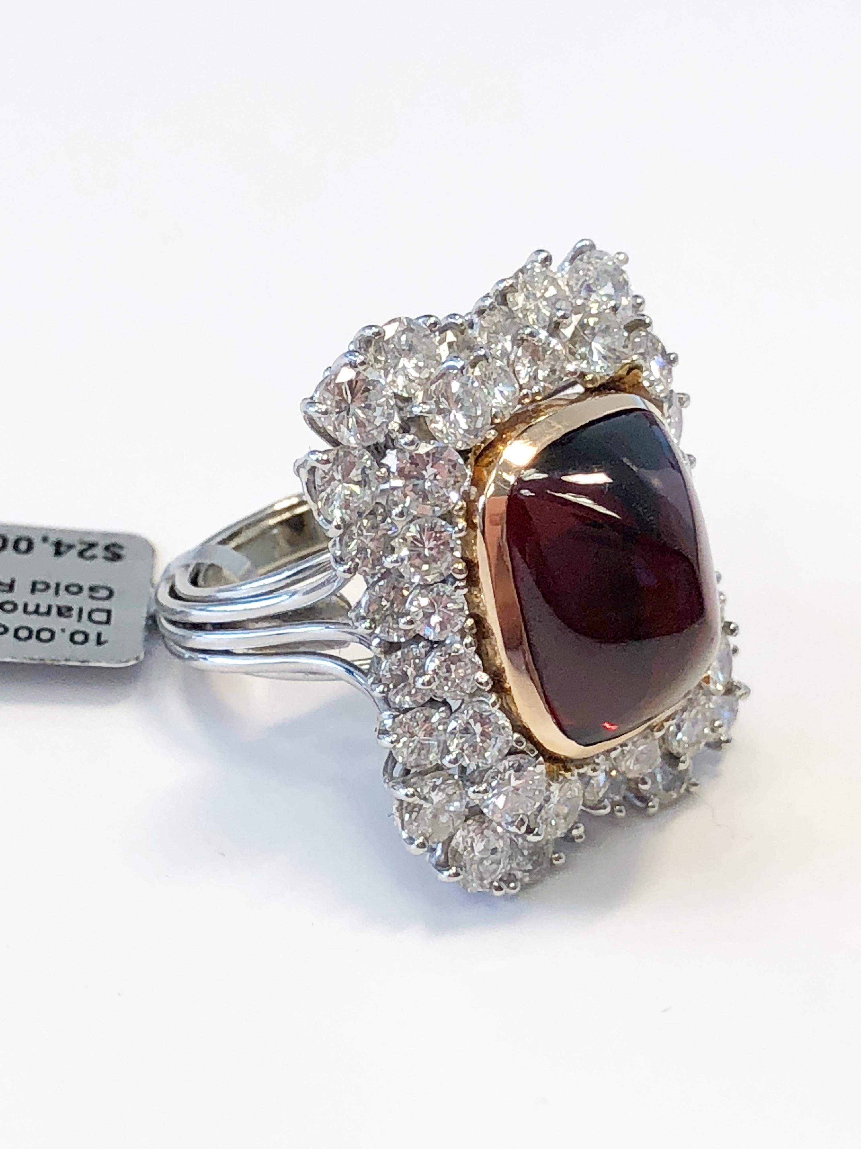 Stunning 10.00 carat sugarloaf garnet with 2.15 carats of good quality bright white diamonds in 18k 2 tone gold.  This garnet is unique in size and color.  Elegant design that showcases the stone's beautiful color and eye catching shape.  Ring size