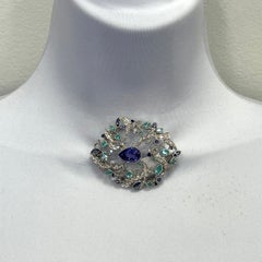 Broche en or 18 carats sertie d'une tanzanite certifiée GIA, d'un paraiba du Mozambique et de diamants blancs