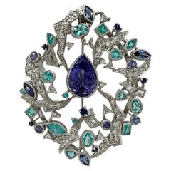 Broche en or 18 carats sertie d'une tanzanite certifiée GIA, d'un paraiba du Mozambique et de diamants blancs