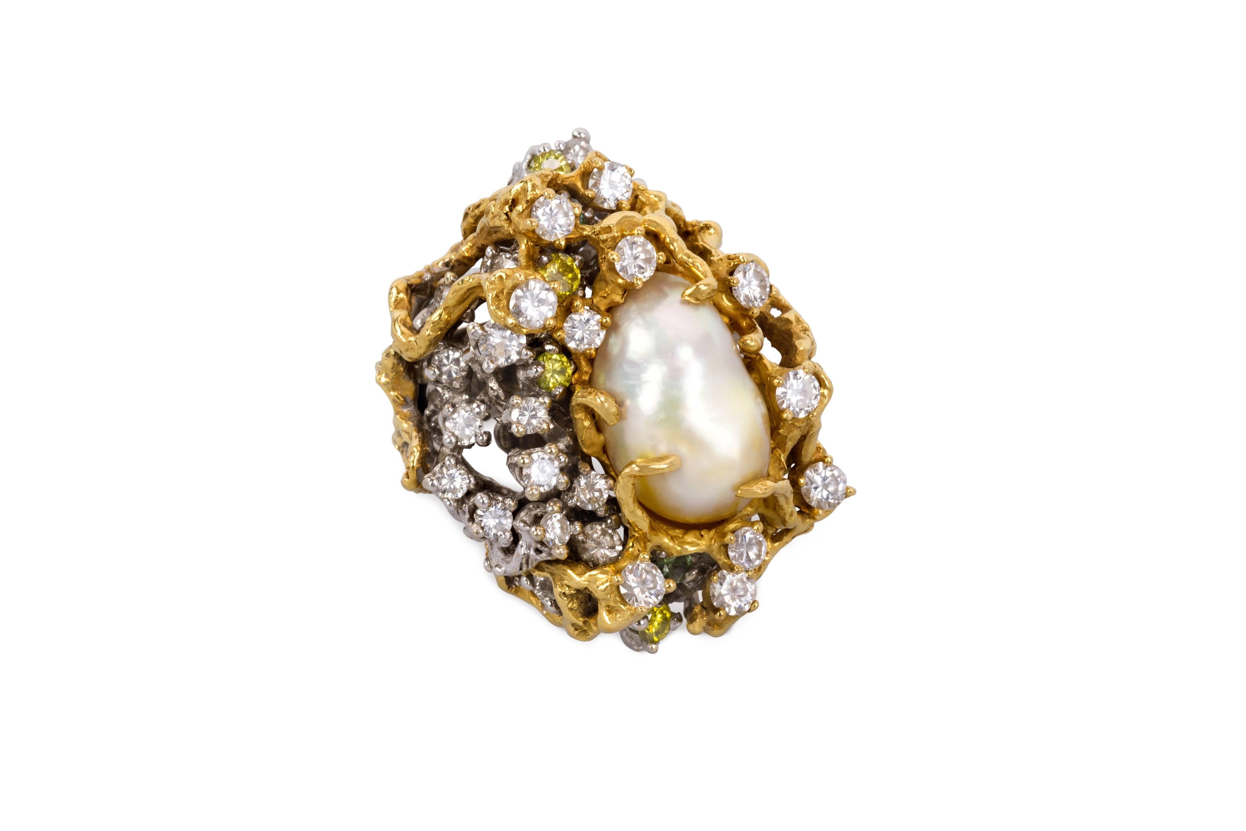 A fabulous cocktail ring featuring a baroque South Sea pearl, colored diamonds and 18 karat yellow and white gold ring, by Arthur King, c. 1970. The ring measures a size 6.75, and is 1.3