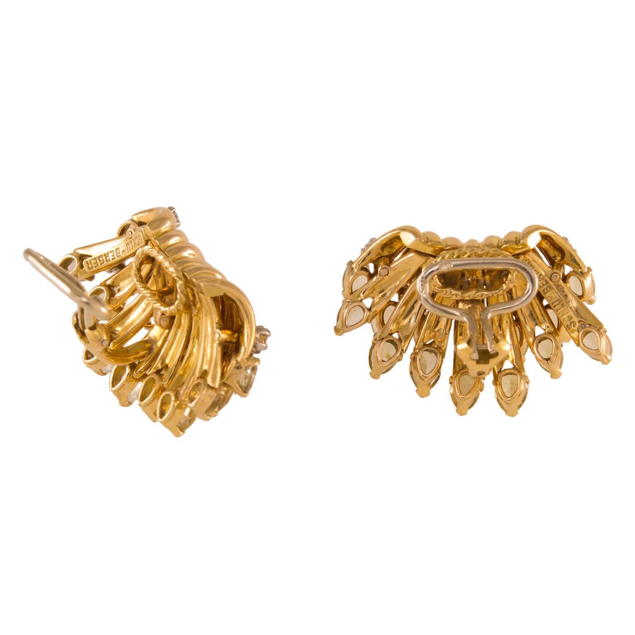 A pair of 18k gold earclips designed by Jean Schlumberger circa 1950. The earrings are set with pear-shaped yellow tourmalines and round diamonds. French marks and signed.