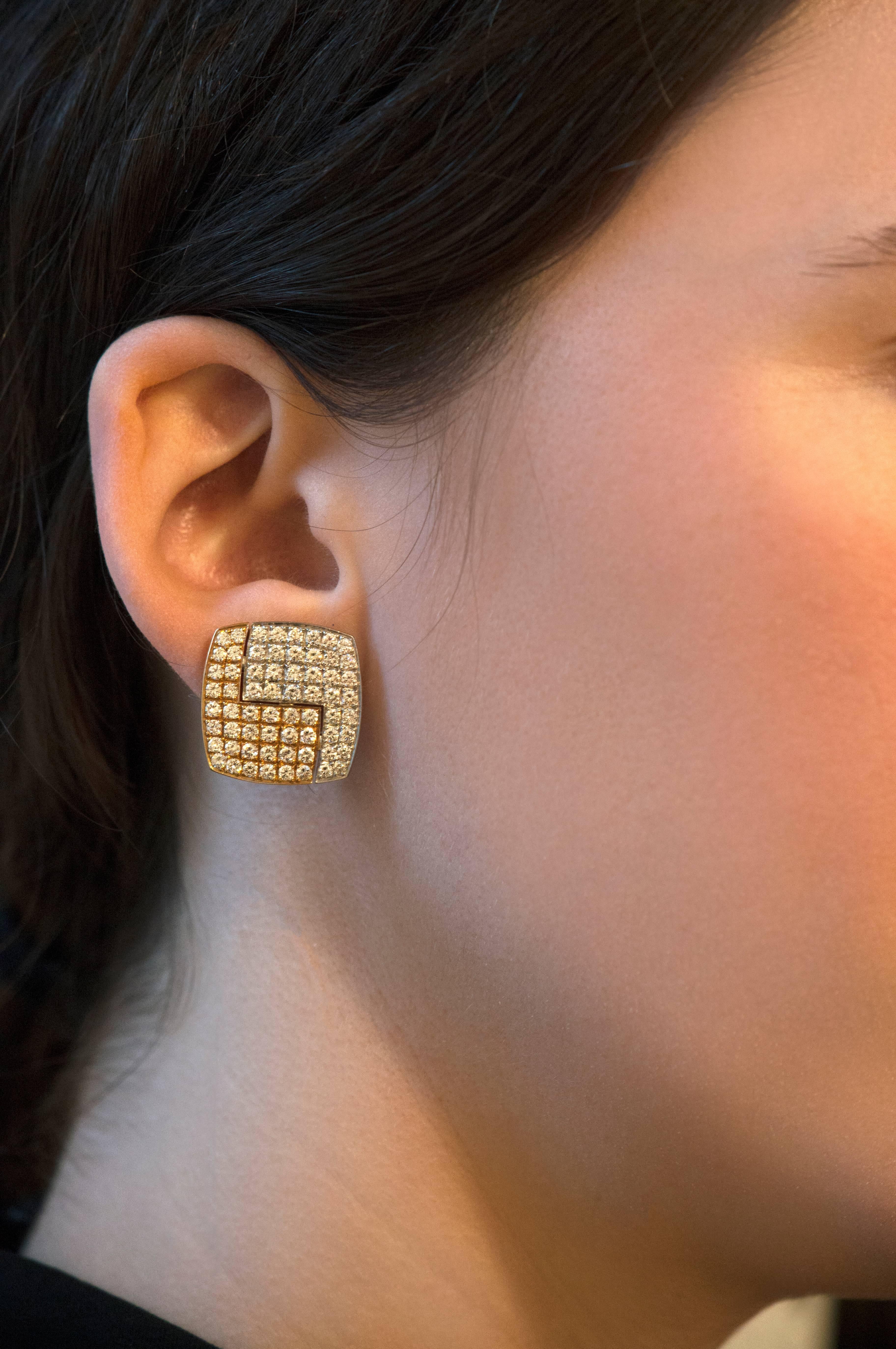 A pair of geometric, 18 karat gold clip-on earrings with approximately 3.9 carats of brilliant cut diamonds made by the admired Swiss master goldsmith, Paul Binder. These earrings measure 0.75