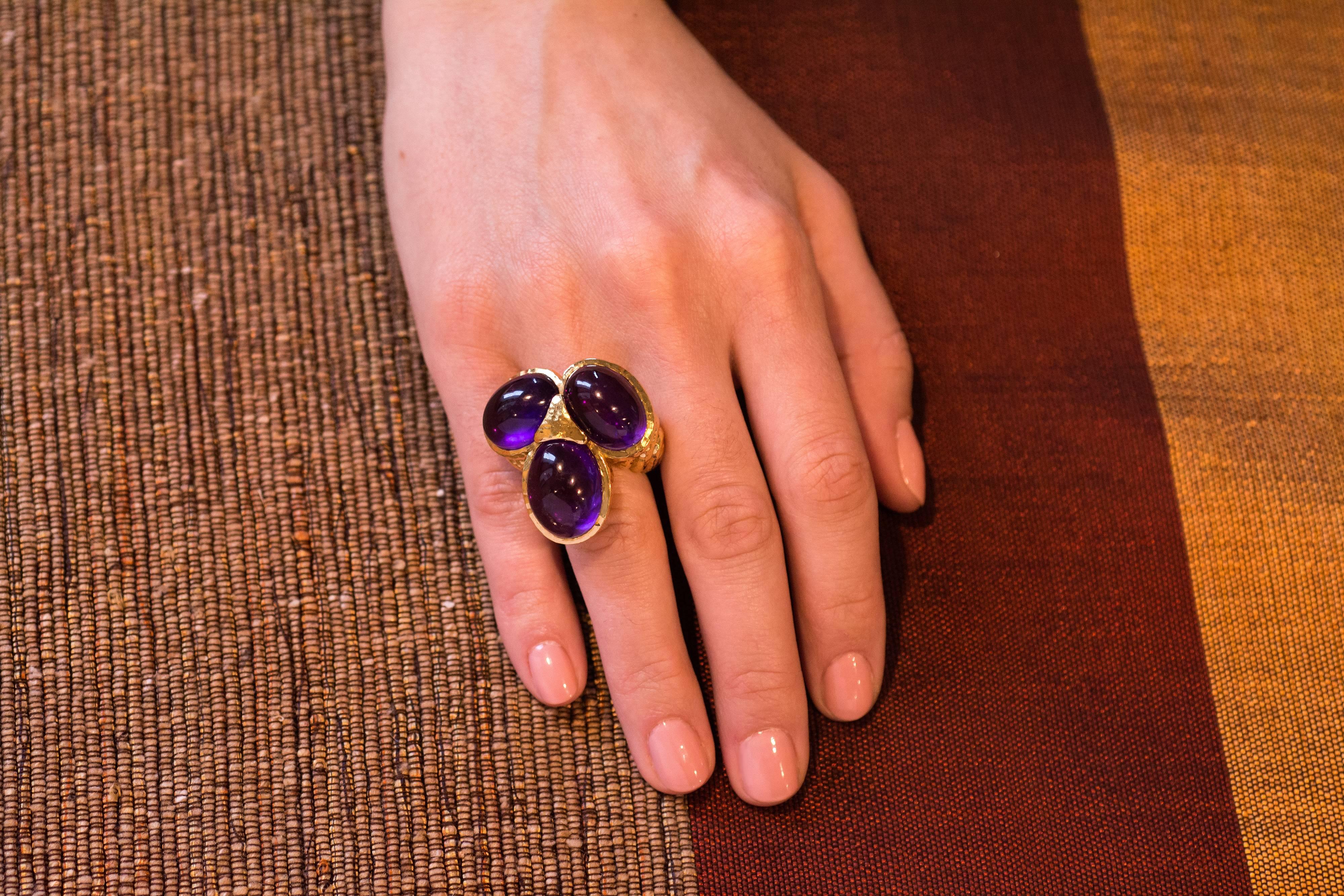 An 18 karat gold and cabochon amethyst trio cocktail ring by David Webb. Size 7.5. Circa1970s.