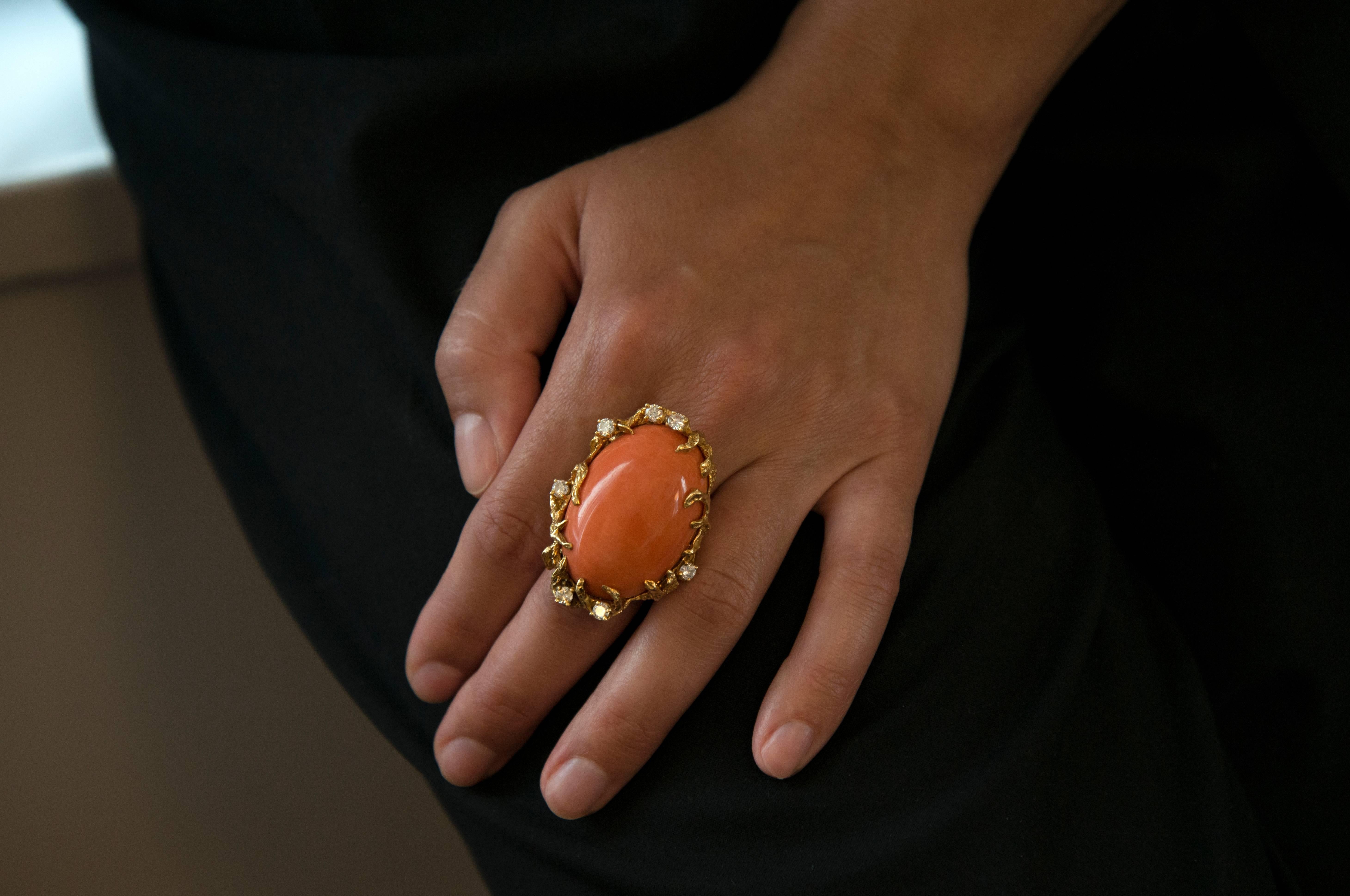 A fabulous coral, diamond and 18 karat gold ring, by Arthur King, 1970s. One-of-a-kind. This ring is a size 7 1/2 and it is signed King and stamped 18k. The oval shape coral is 1.5