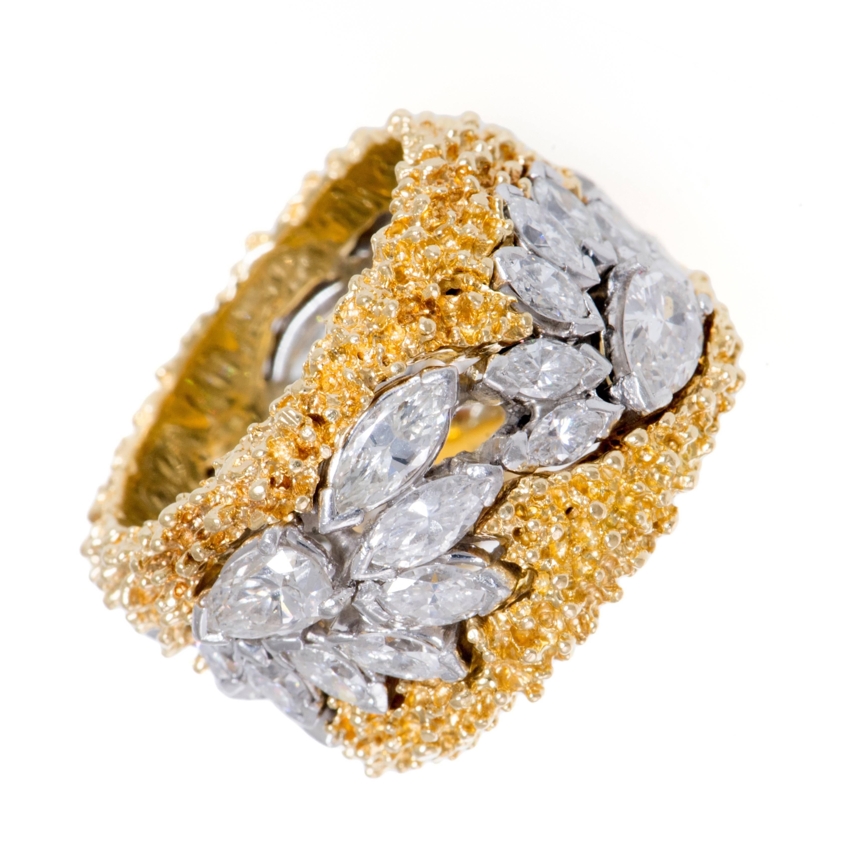 5.5 carats of marquise and pear cut diamonds, set in platinum, fan around the circumference of this handmade heavy 18 karat textured gold ring. The band is a size 7.
